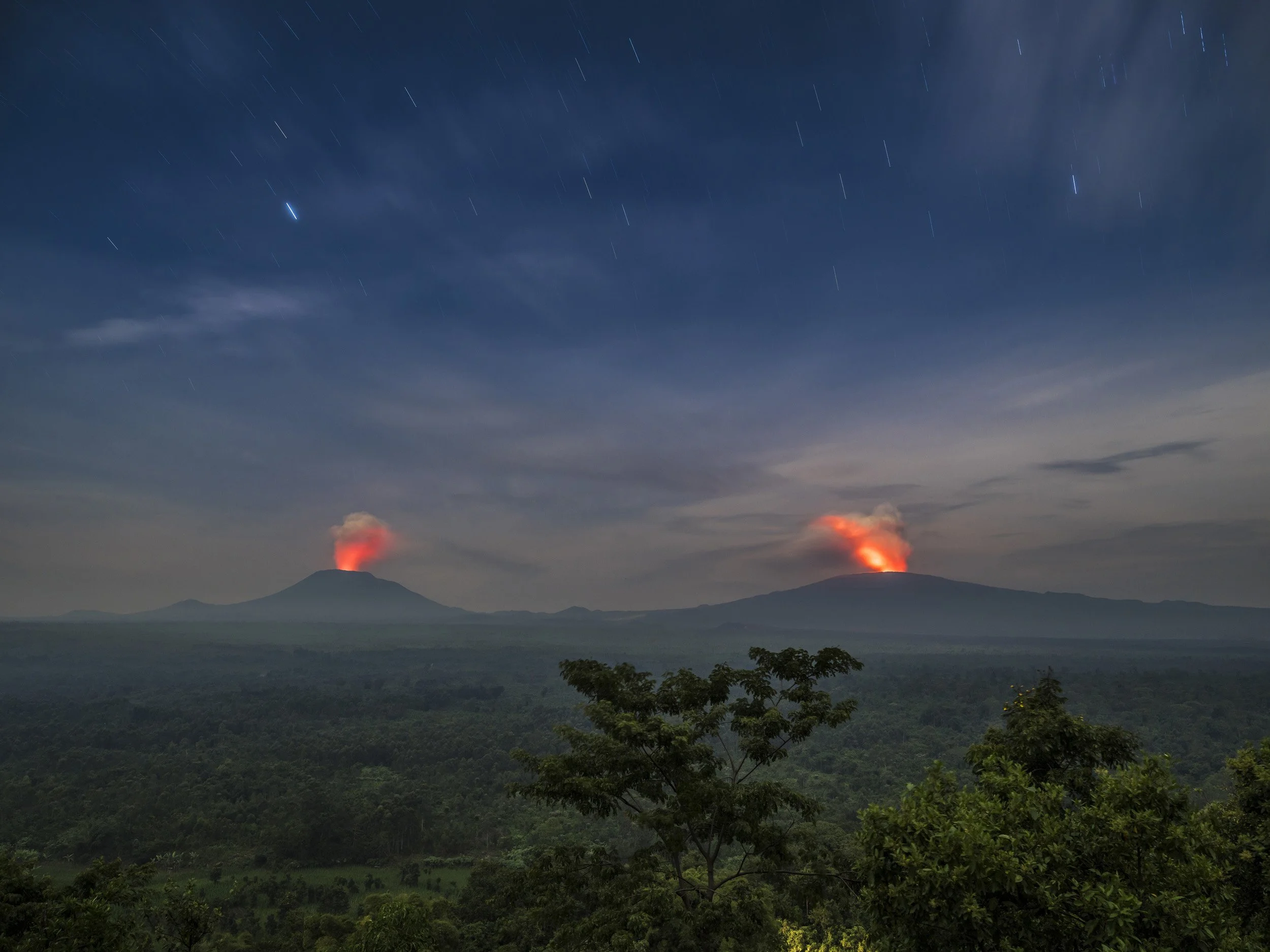 RUMANGABO, VIRUNGA NATIONAL PARK, DR CONGO, 2 MAY 2015: Moonlit images of active volcanoes within Virunga National Park, Mount Nyiragongo and Nyamuragira. Virunga has some of the most active volcanoes on the continent and offers tourism trips to Nyi