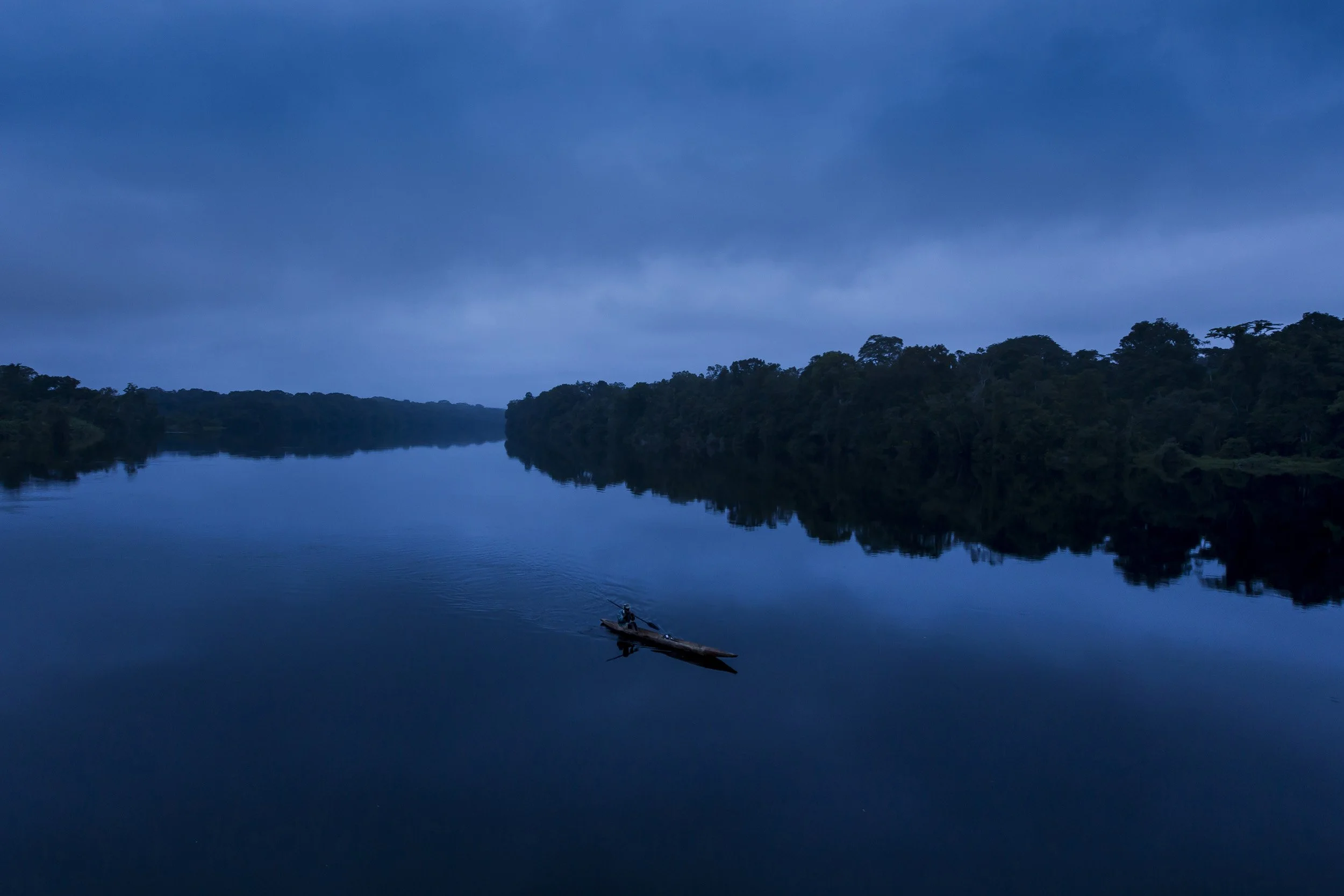 SING RIVER, MINKEBI NATIONAL PARK, GABON, JUNE 2011: An anti-poaching team composed of Gabon Parcs personal, Gabon military, Baka pygmy porters and two Pirouge pilots conduct an anti-poaching mission up the Sing River in Minkebi National Park, Gabon