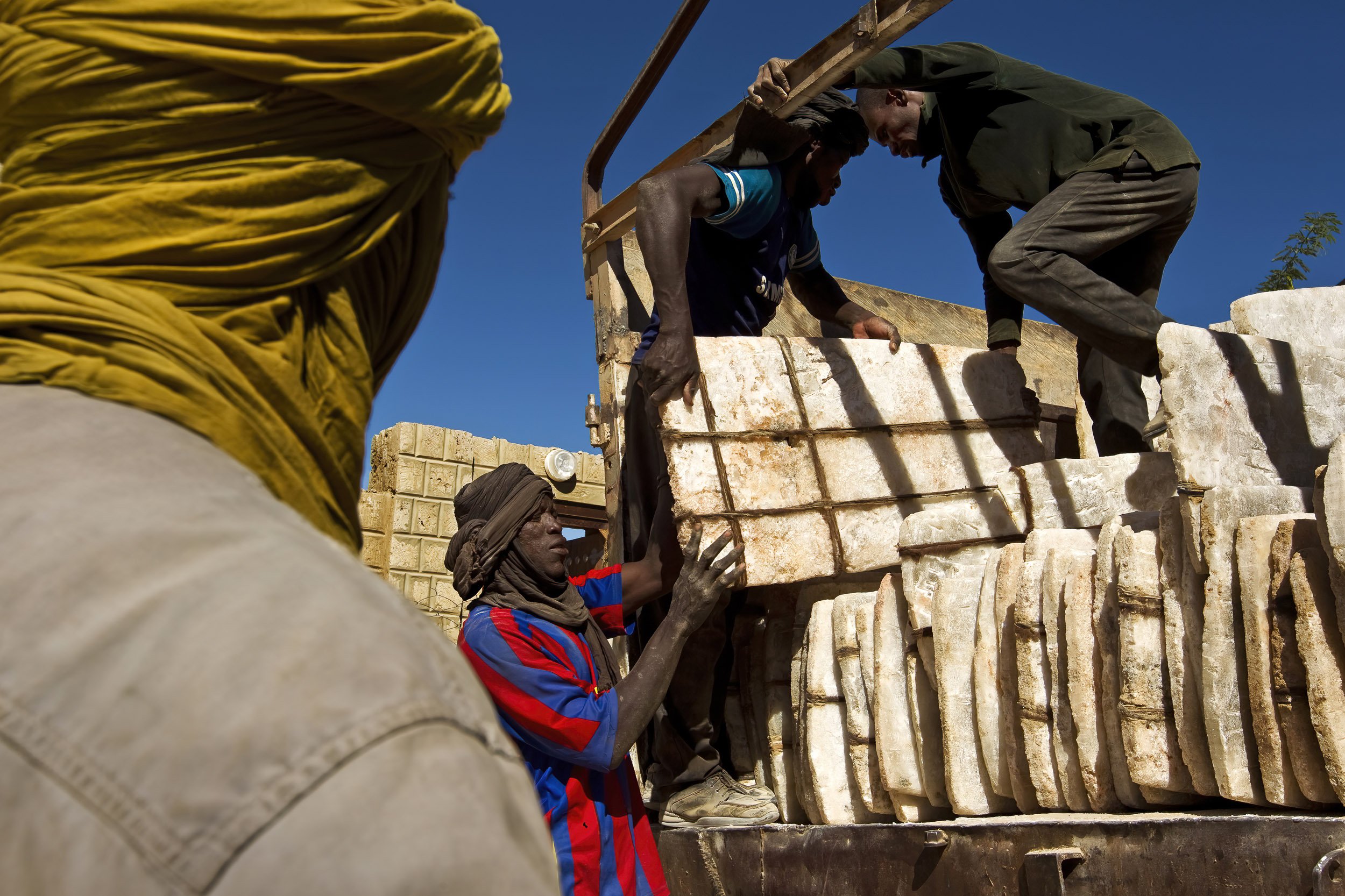 TIMBUKTU, MALI, JANUARY 2010: A truck delivers salt tablets from Taodenni, a salt mine in the north of Mali, to the home of an Arab businessman in Timbuktu, Mali, 22 January 2010. The salt industry is in transition, long the province of the Tuareg a