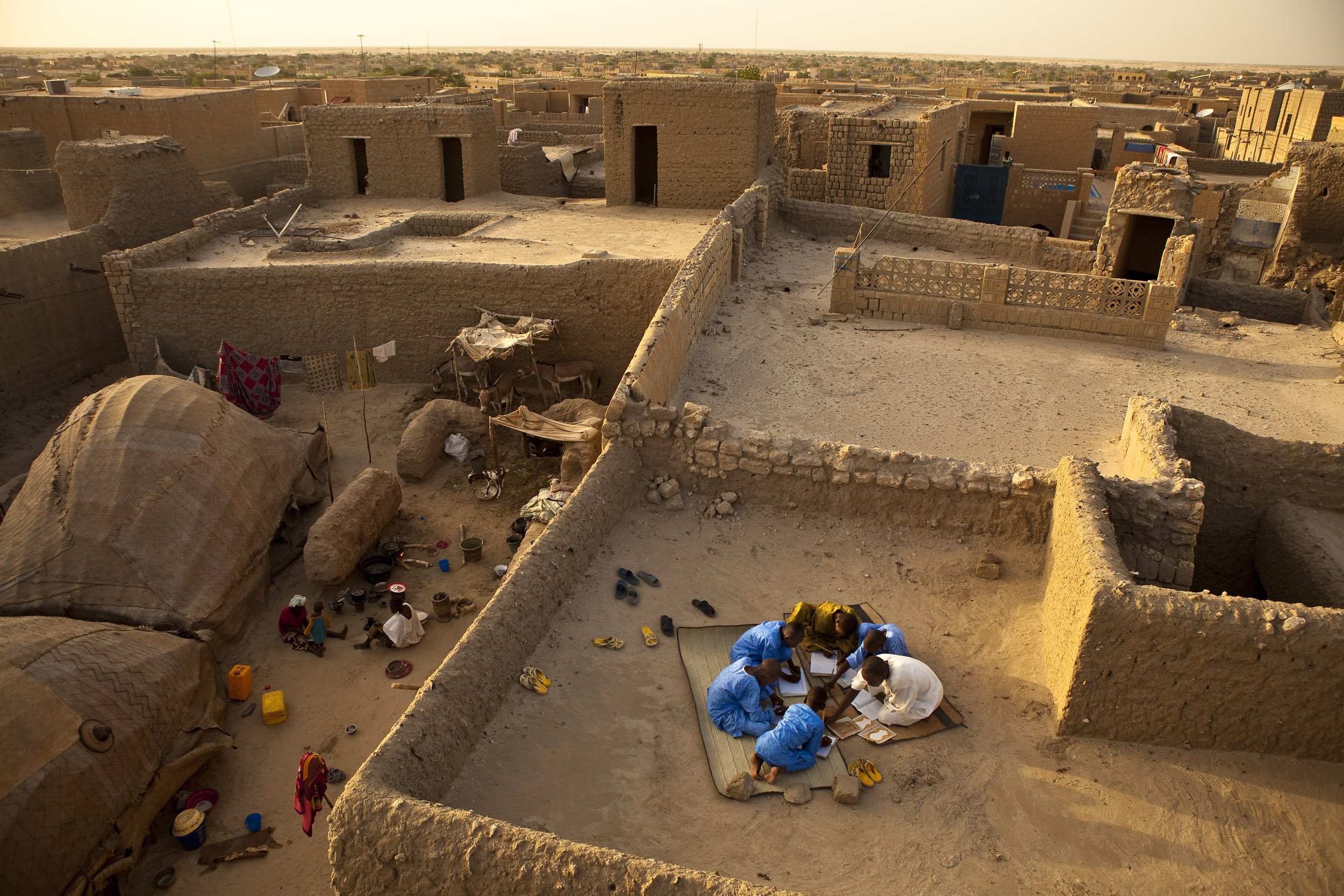 TIMBUKTU, SEPTEMBER 2009: Caligrapher and Copyist Buboubacar Sadeck teaches students the art of ancient caligraphy on a Timbuktu rooftop, September 8, 2009. Timbuktu is a historical Malian city, a long established centre of learning for Africa, Is