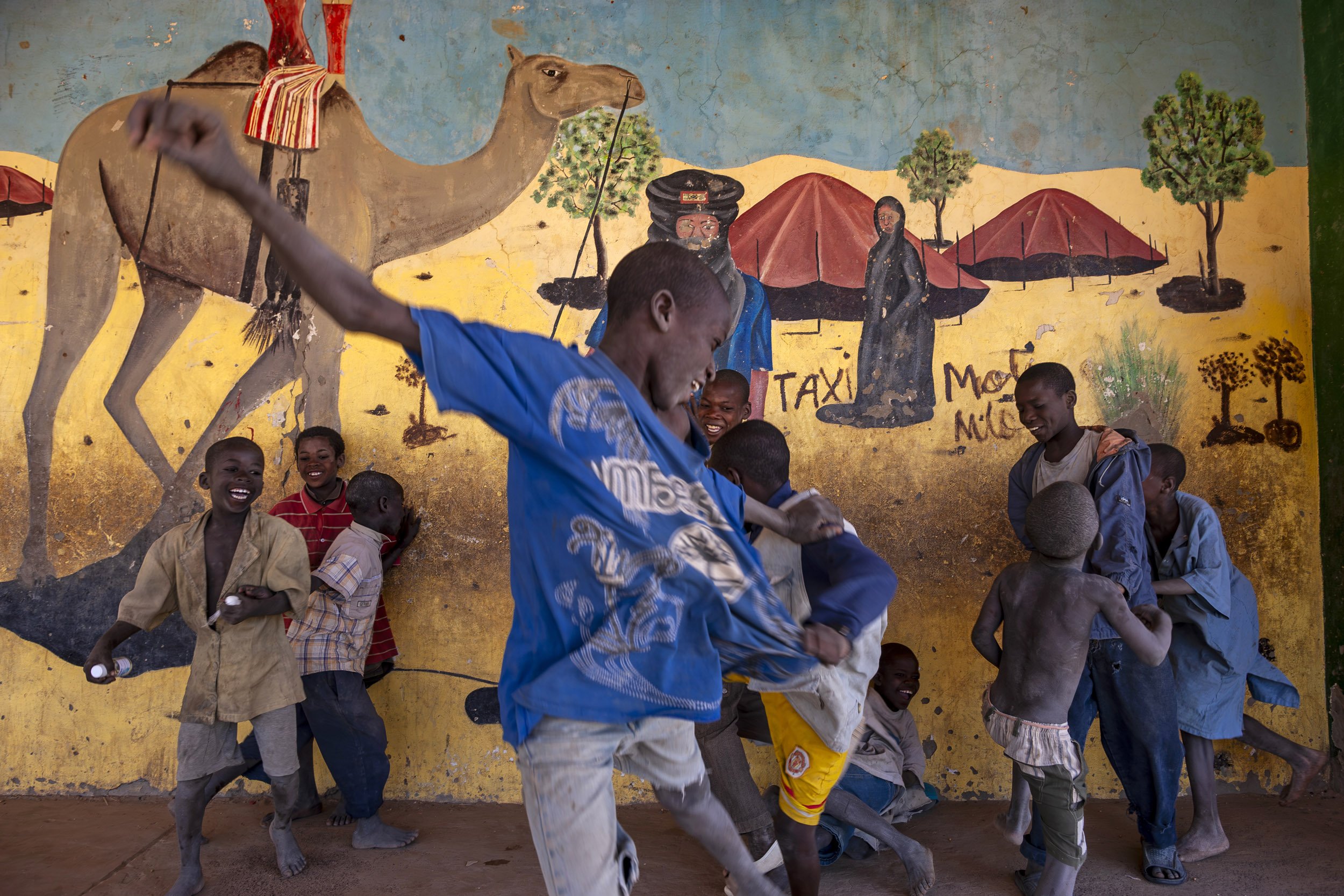 TIMBUKTU, MALI, JANUARY 2010: Boys play soccer near a Tuareg desert mural in the center of Timbuktu, the mythical Northern Mali city, 22 January 2010. (Photo by Brent Stirton/Reportage by Getty images.)
