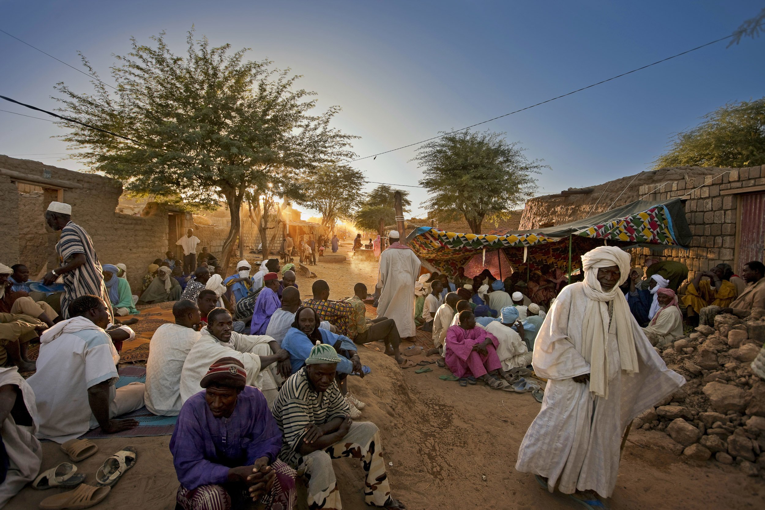 TIMBUKTU, MALI, JANUARY 2010: Late Afternoon scenes at a funeral in the streets of Timbuktu, MALI, 5 JANUARY 2010. Funerals in Timbuktu are conducted separately, with the woman mourning inside the house of the deceased and the men outside on the str
