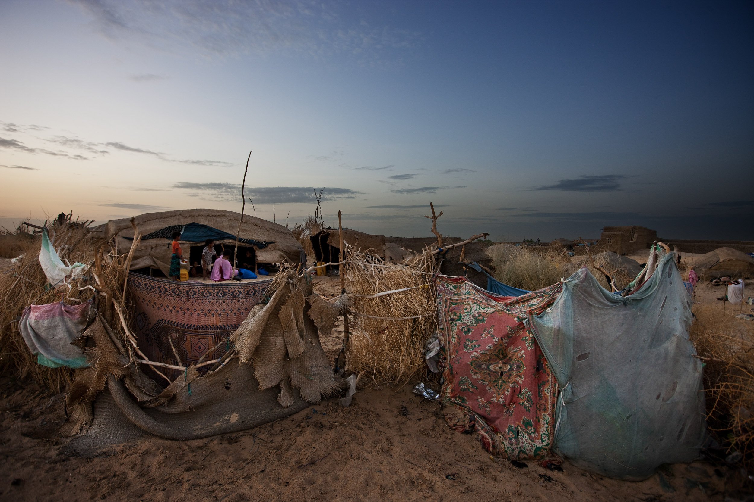 TIMBUKTU, SEPTEMBER 2009: Tuareg and Songhay nomad families camped on the outskirts of Timbuktu during the rainy season, September 6, 2009. The nomads have used this route for centuries, using the same campsites as their forefathers for centuries.