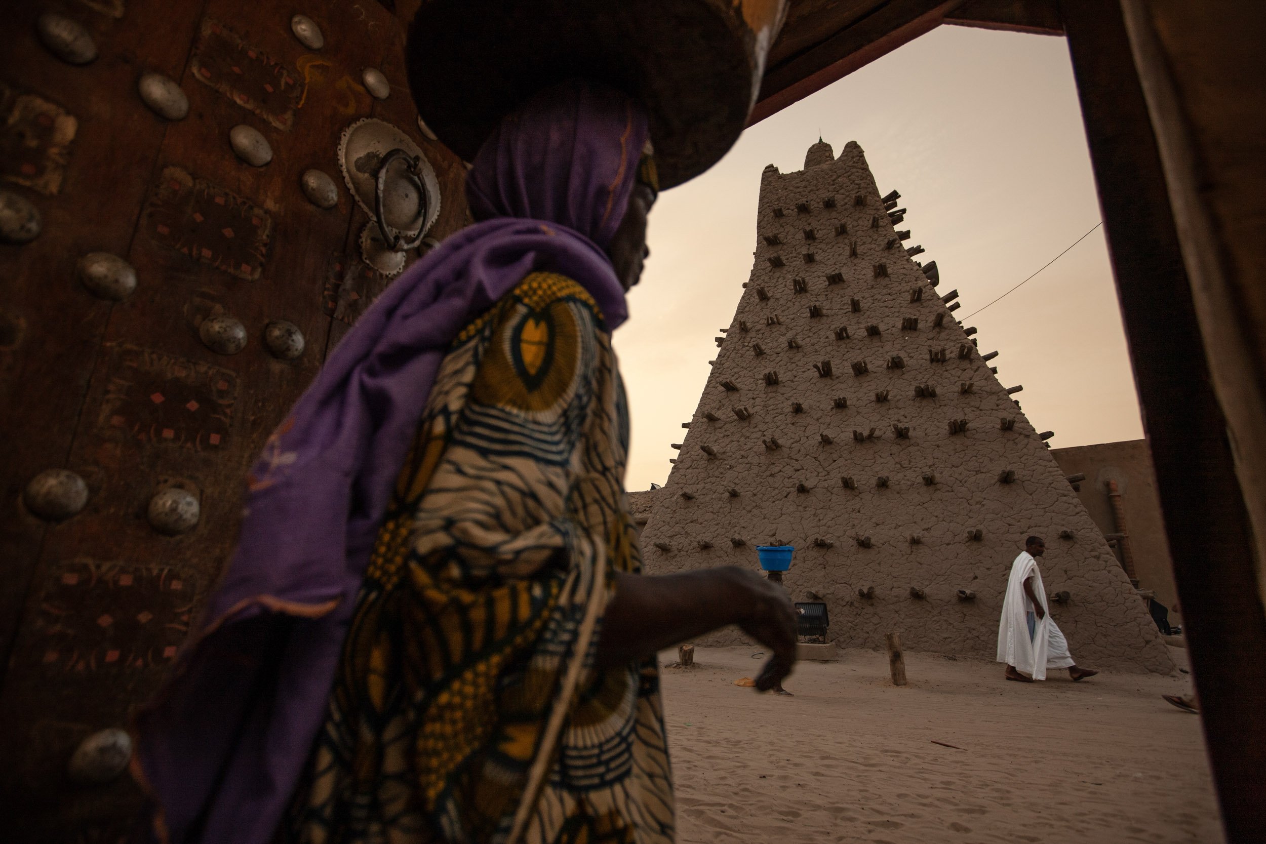 TIMBUKTU, SEPTEMBER 2009: Late afternoon street scenes around the Sankore Mosque as seen from a local residence with the famous Timbuktu door in evidence, Sankore is one of 3 mosques declared UNESCO sites in Timbuktu, a historical Malian city, a lon