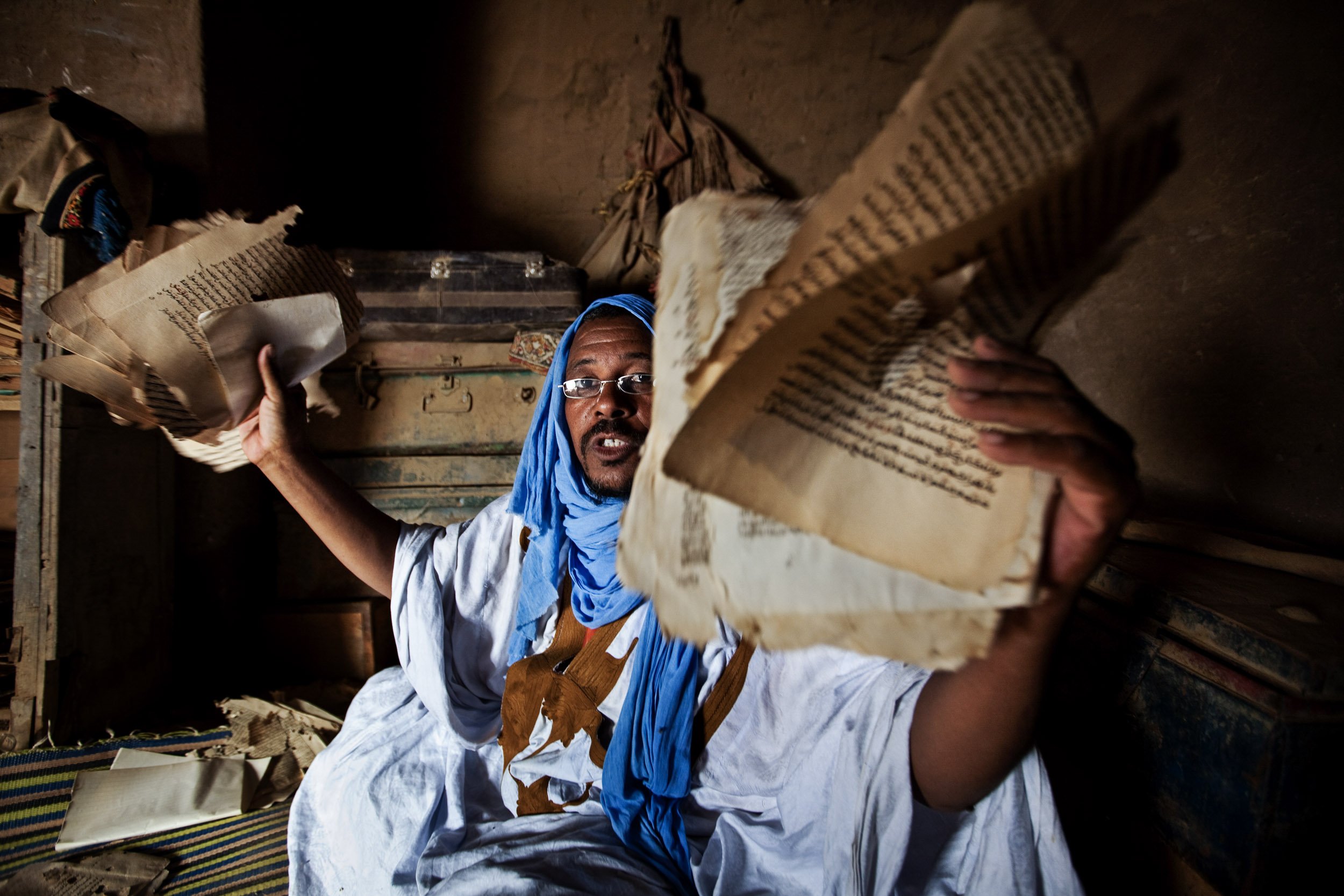 TIMBUKTU, SEPTEMBER 2009: Imam Chafi, custodian of the Biblioteche Cheik Na Boulher, sits in the rain damaged library trying to sort out salvagable manuscripts dating back to the 18th century, Timbuktu, September 7, 2009. Timbuktu is a historical M