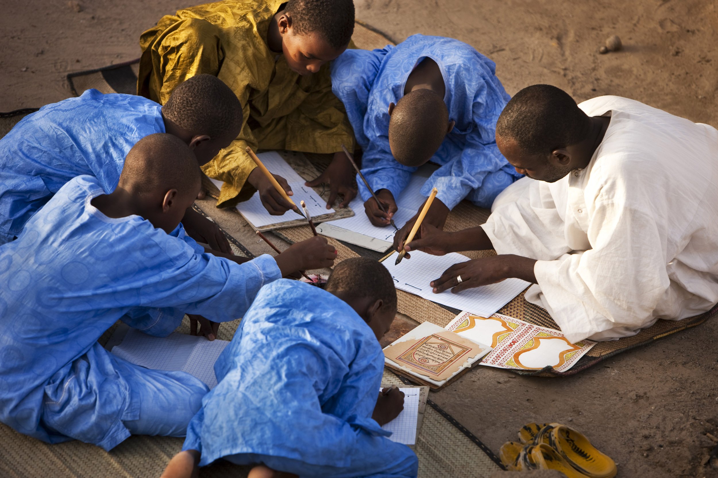 TIMBUKTU, SEPTEMBER 2009: Caligrapher and Copyist Buboubacar Sadeck teaches students the art of ancient caligraphy on a Timbuktu rooftop, September 8, 2009. Timbuktu is a historical Malian city, a long established centre of learning for Africa, Is