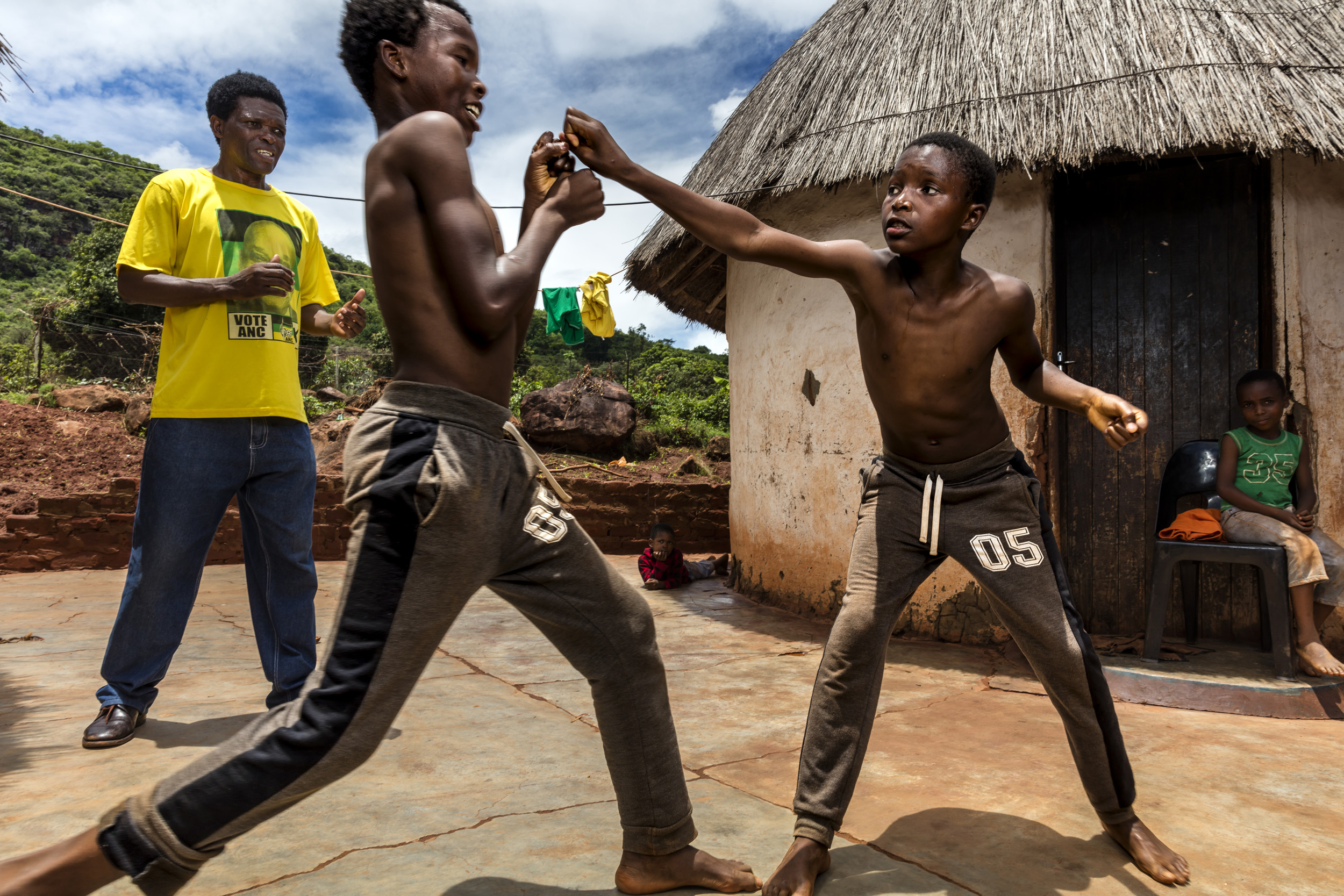 VENDA, SOUTH AFRICA, 11 DECEMBER 2016: "Poison" Ndevana, 58, is the president of the Musangwe Comittee in Venda, he is seen training his two eldest boys Mudshidzi, 15, and Nanjana, 13. Poison says his two eldest are still too young to train seriousl