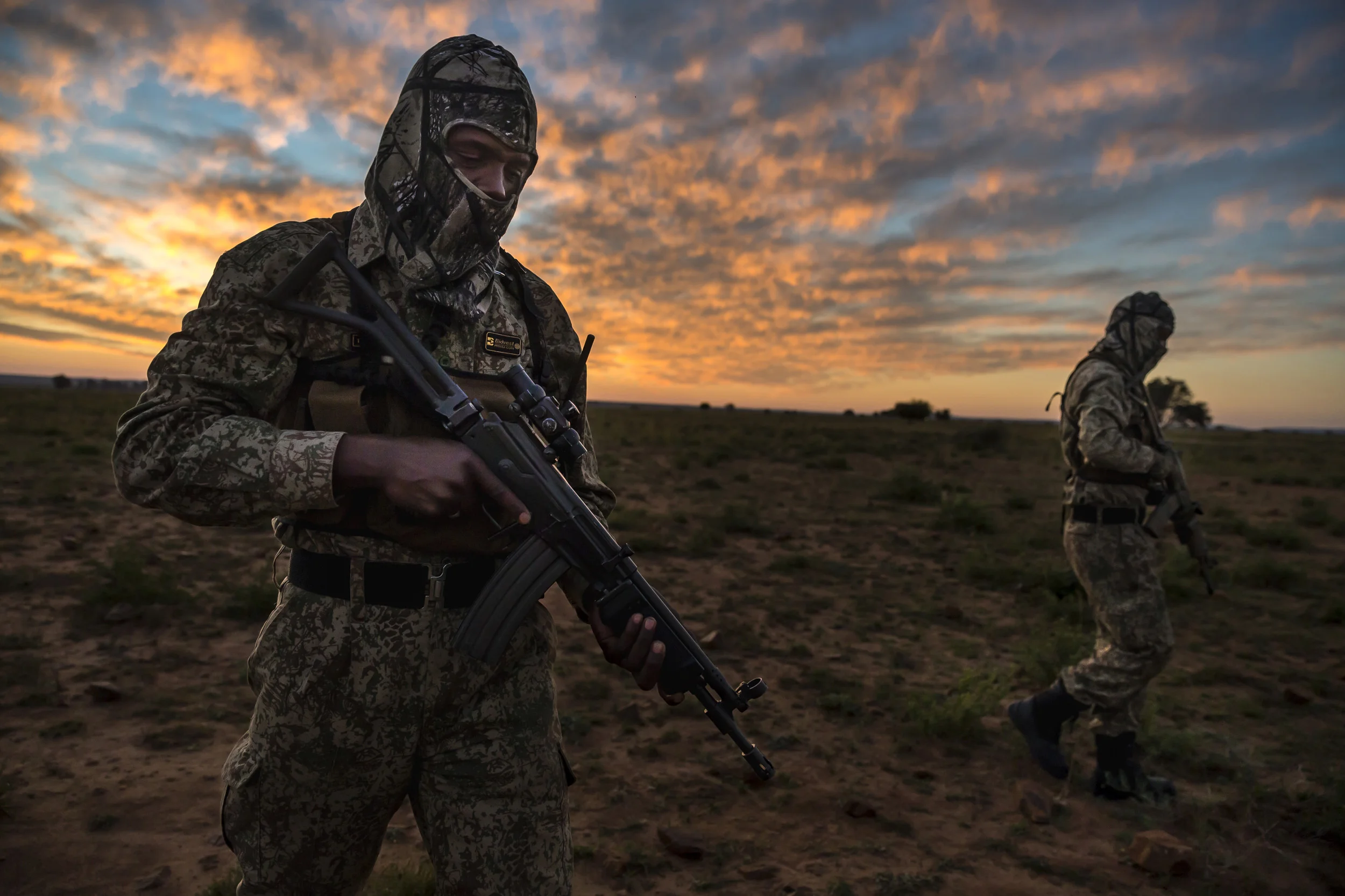 BUFFALO DREAM RANCH, KLERKSDORP, SOUTH AFRICA, 24 MAY 2016: A two-man security team deploys by helicopter at sunset for anti-poaching duties on the worlds largest Rhino breeding ranch. The teams are at work 24 hours a day and conduct security opera