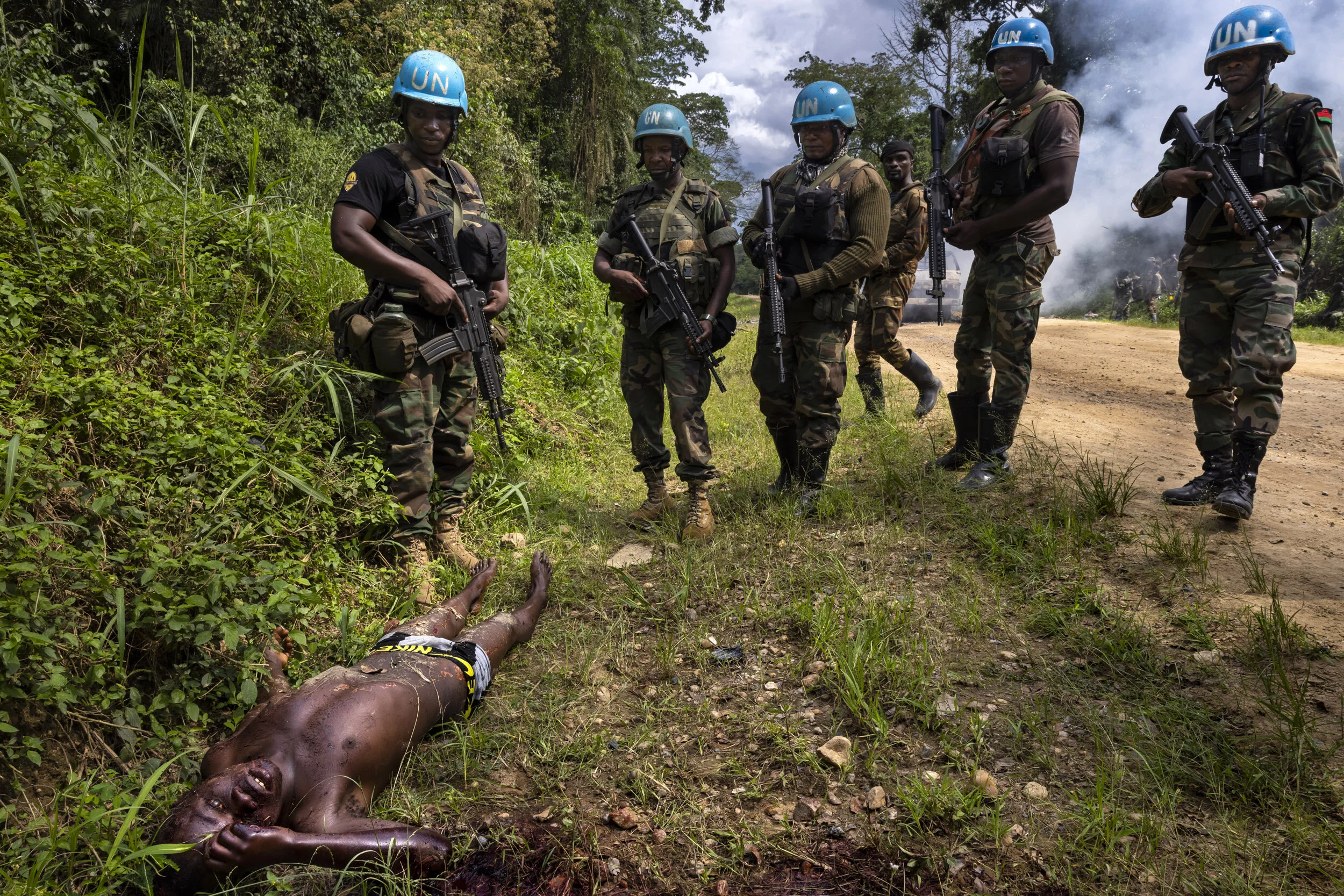 KILYA, RWENZORI SECTOR, DEMOCRATIC REPUBLIC OF CONGO, 9 APRIL 2021: Congolese Army soldiers and UN forces inspect an ambush site where an hour previously A.D.F fundamentalist rebels attacked two vehicles on the road between Beni and the Ugandan bord