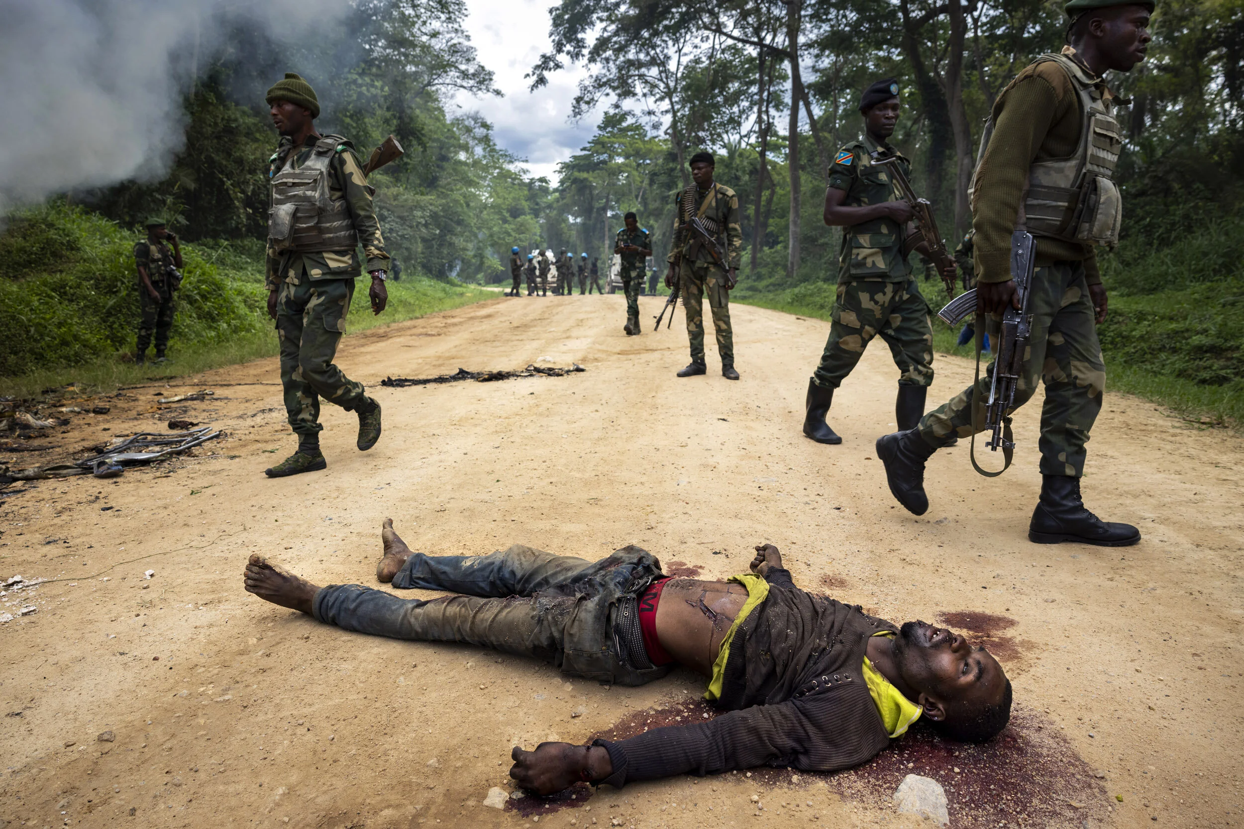 KILYA, RWENZORI SECTOR, DEMOCRATIC REPUBLIC OF CONGO, 9 APRIL 2021: Congolese Army soldiers and UN forces inspect an ambush site where an hour previously A.D.F fundamentalist rebels attacked two vehicles on the road between Beni and the Ugandan bord