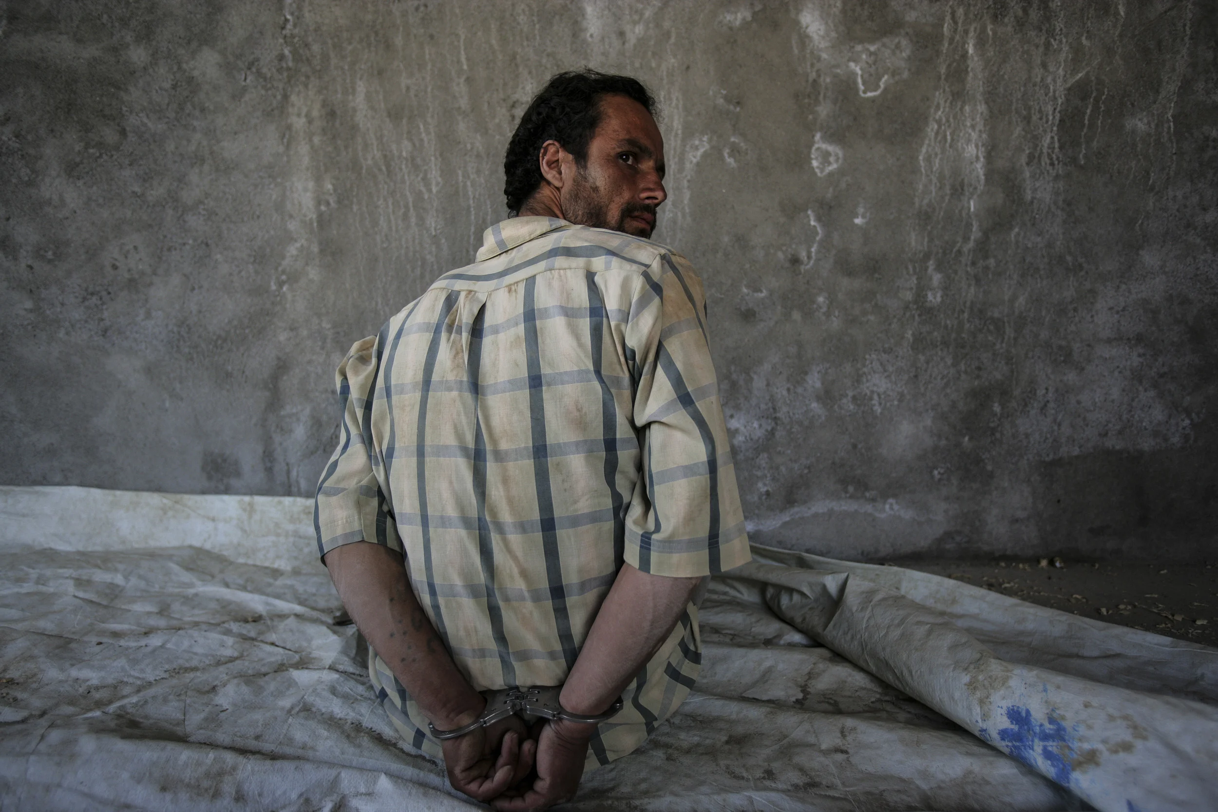KABUL, AFGHANISTAN-APRIL 2007: Scenes from a drugs bust conducted by the Afghan Anti-Narcotics unit assisted by American DEA agents who have been training these men for over 2 years, Kabul, Afghanistan, 18 April 2007. The images show a search scene