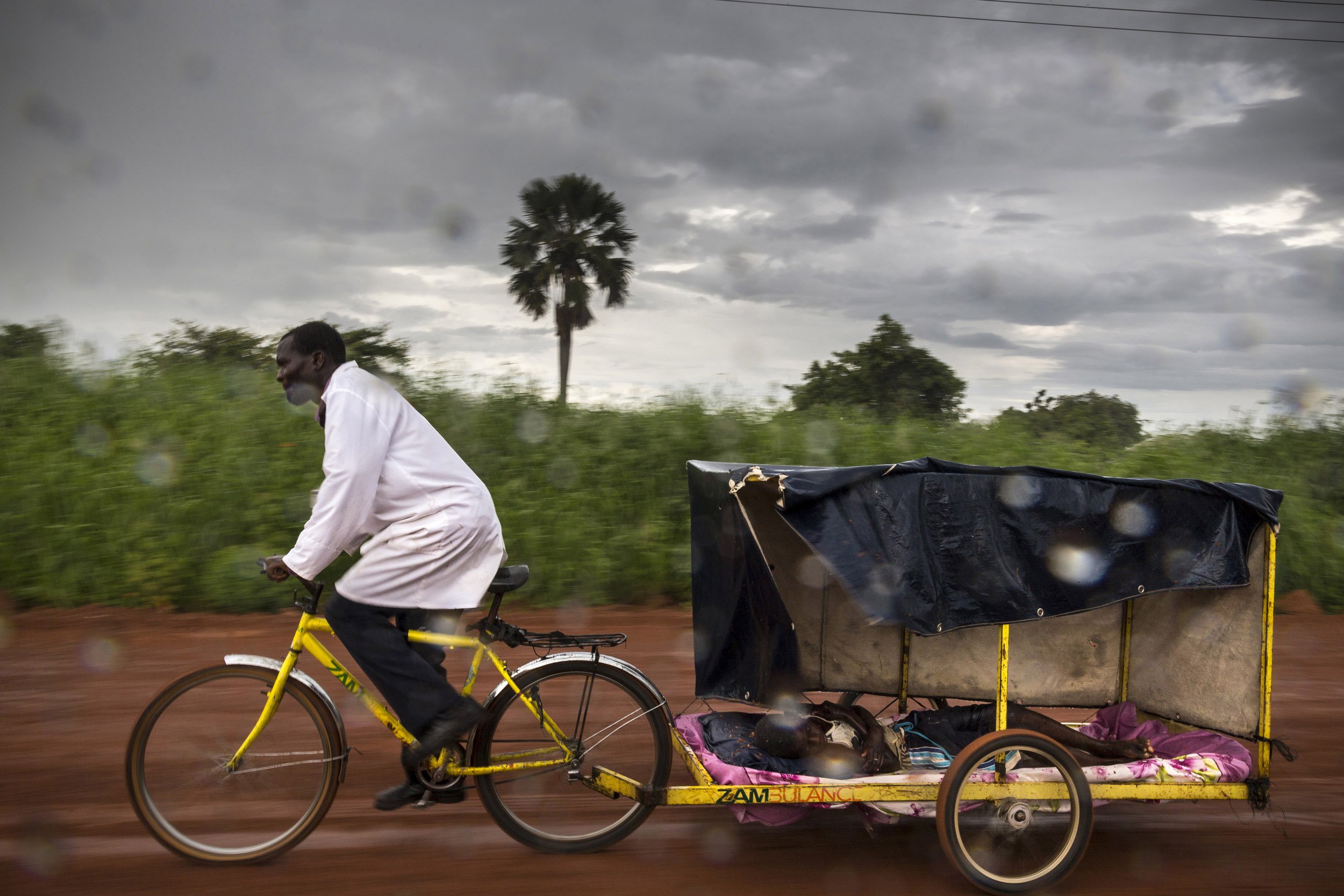 Novartis Pharmaceutical Annual report - work on Malaria as seen through trained nurses in remote areas of Africa working with bicycle ambulances and mobile testing
