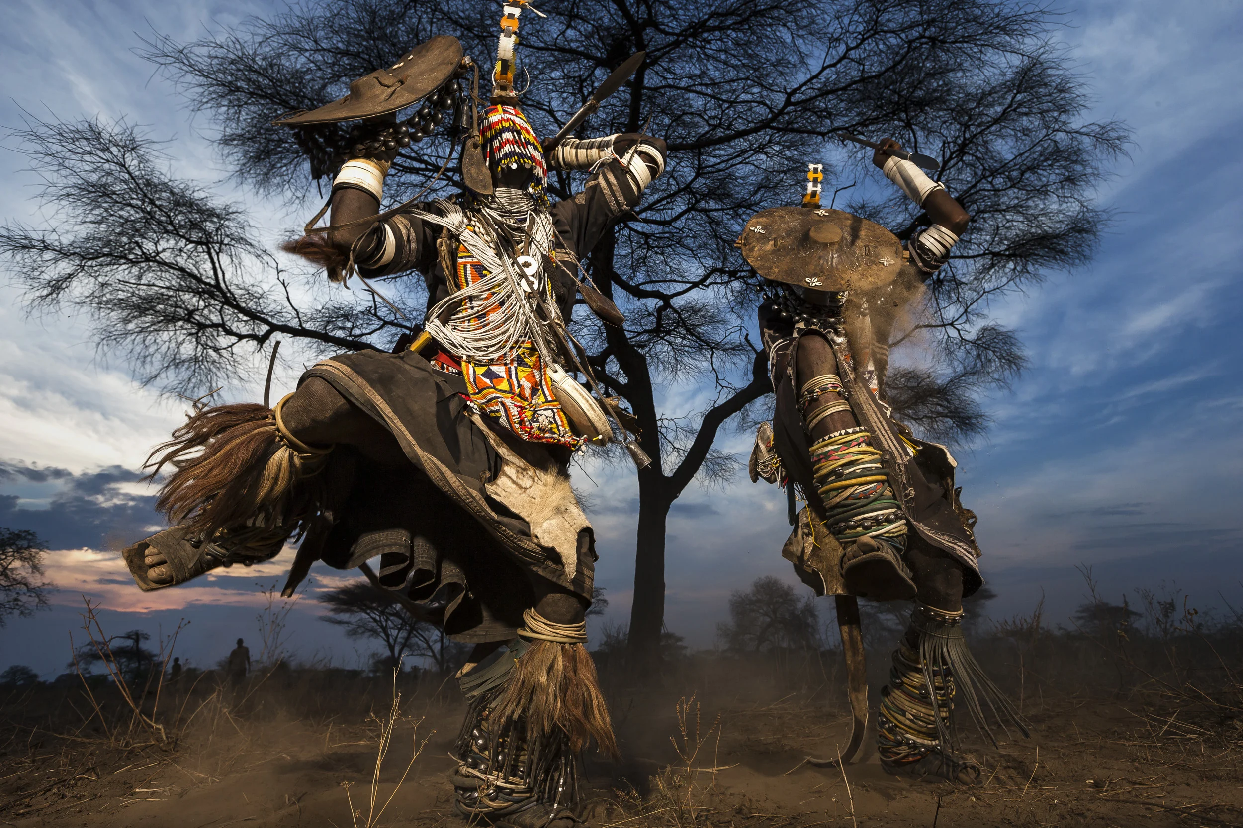 MPIMBWE, WESTERN TANZANIA, OCTOBER 2012: Lion Dancers from the Sakuma tribe perform the story of their lion killing outside a village in rural Mpimbwe, Western Tanzania, October 27, 2012. Lion dancers are men who have killed a lion in defense of the