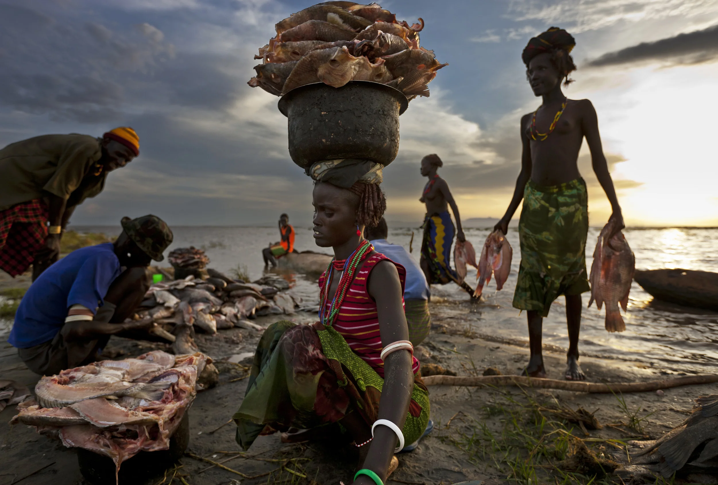 LAKE TURKANA, NORTHERN KENYA, MAY 2010: Dasenetch pastoralist people with their catch of Tilapia fish in Lake Turkana in North Kenya, 20 May 2010. Fishing is a relatively new phenomenon for the Dasenetch, drought and climate change have forced them
