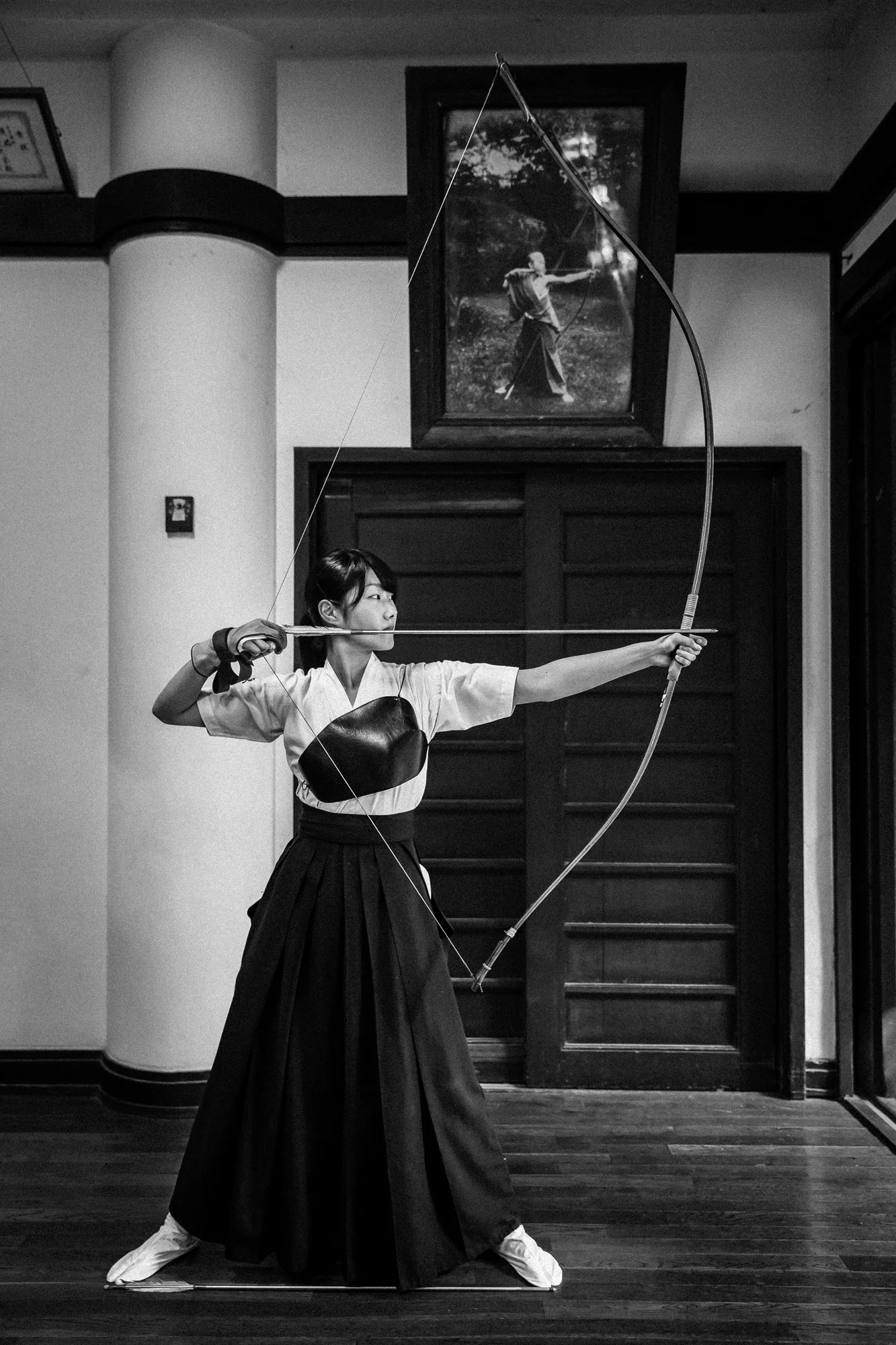 TOKYO UNIVERSITY, TOKYO, JAPAN, 25 OCTOBER 2014: Tokyo University Kyudo club in action at the University dojo, Tokyo, Japan. Kyudo is much more a moving meditation than a sport of archery, with an emphasis on breath, perfection of movement than an a