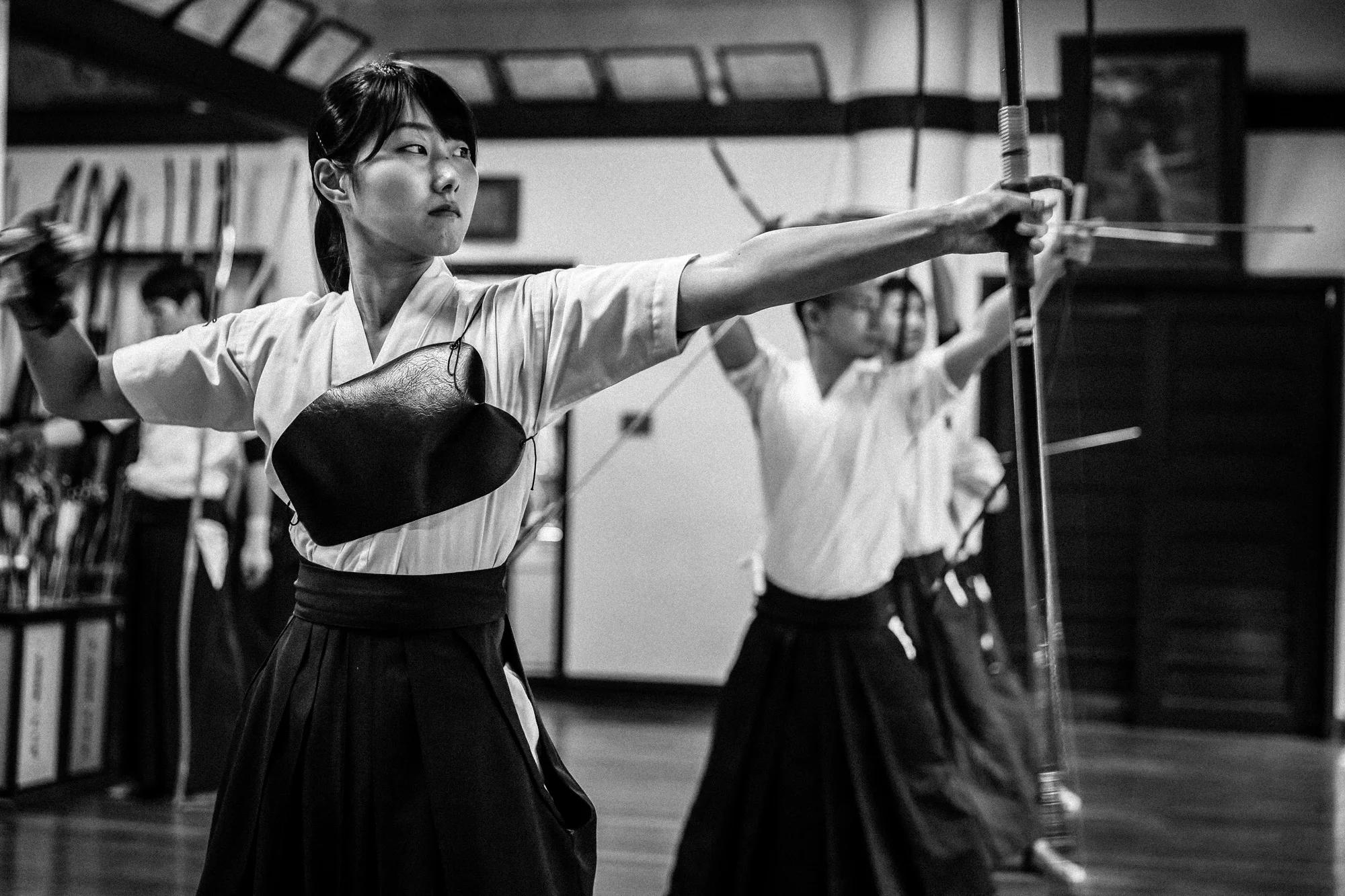 TOKYO UNIVERSITY, TOKYO, JAPAN, 25 OCTOBER 2014: Tokyo University Kyudo club in action at the University dojo, Tokyo, Japan. Kyudo is much more a moving meditation than a sport of archery, with an emphasis on breath, perfection of movement than an a