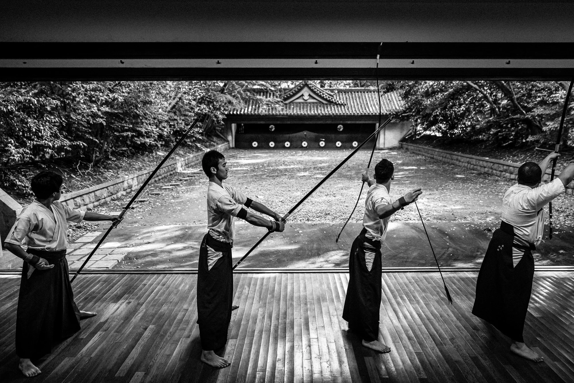 TOKYO UNIVERSITY, TOKYO, JAPAN, 25 OCTOBER 2014: Tokyo University Kyudo club in action at the University dojo, Tokyo, Japan. Kyudo is much more a moving meditation than a sport of archery, with an emphasis on breath, perfection of movement than an a