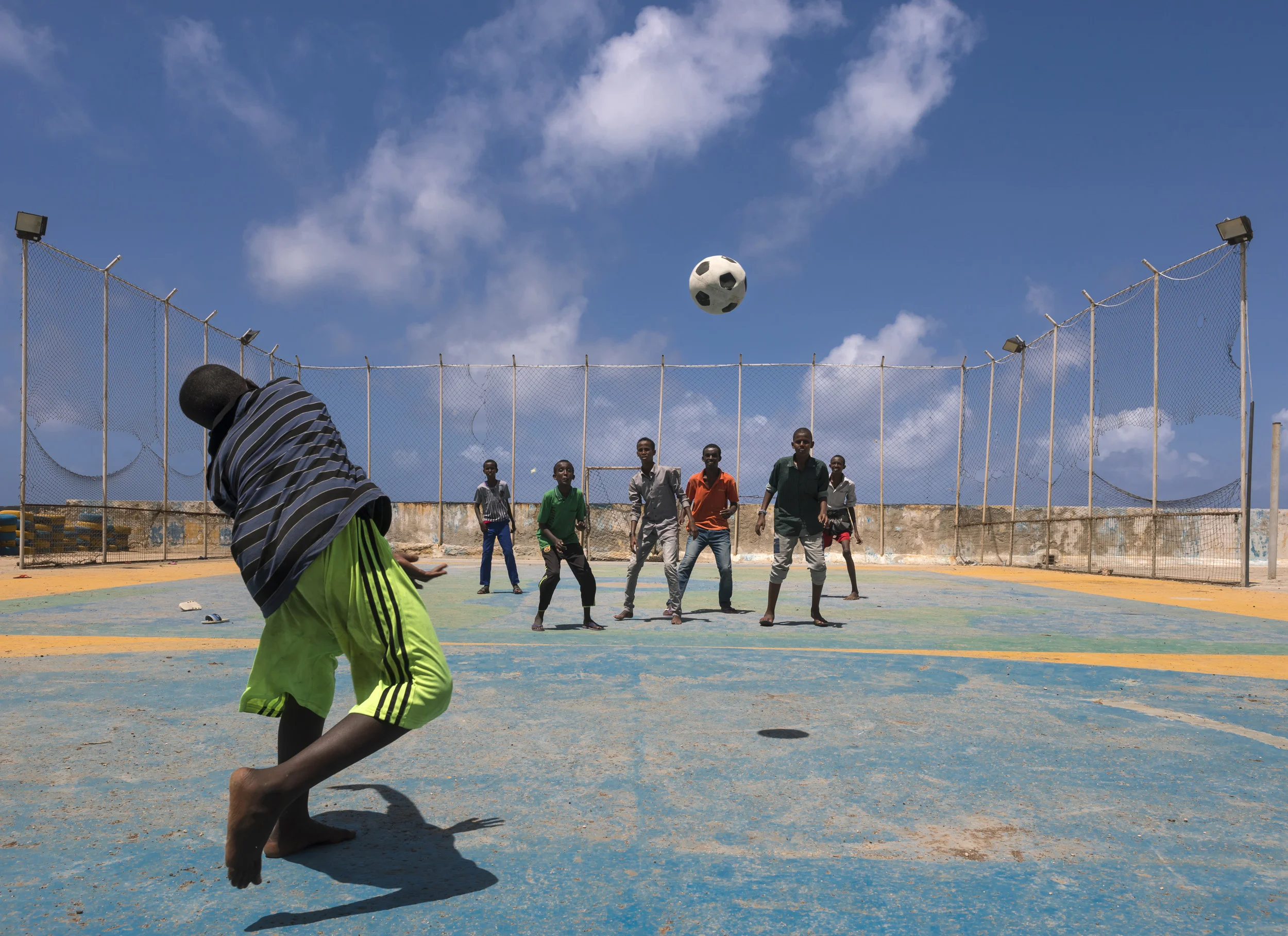MOGADISHU, SOMALIA, 2 AUGUST 2017: Young boys play football on a concrete pitch along the foreshore of the Mogadishu beachfront. (Photo by Brent Stirton/Verbatim for Time Magazine.)