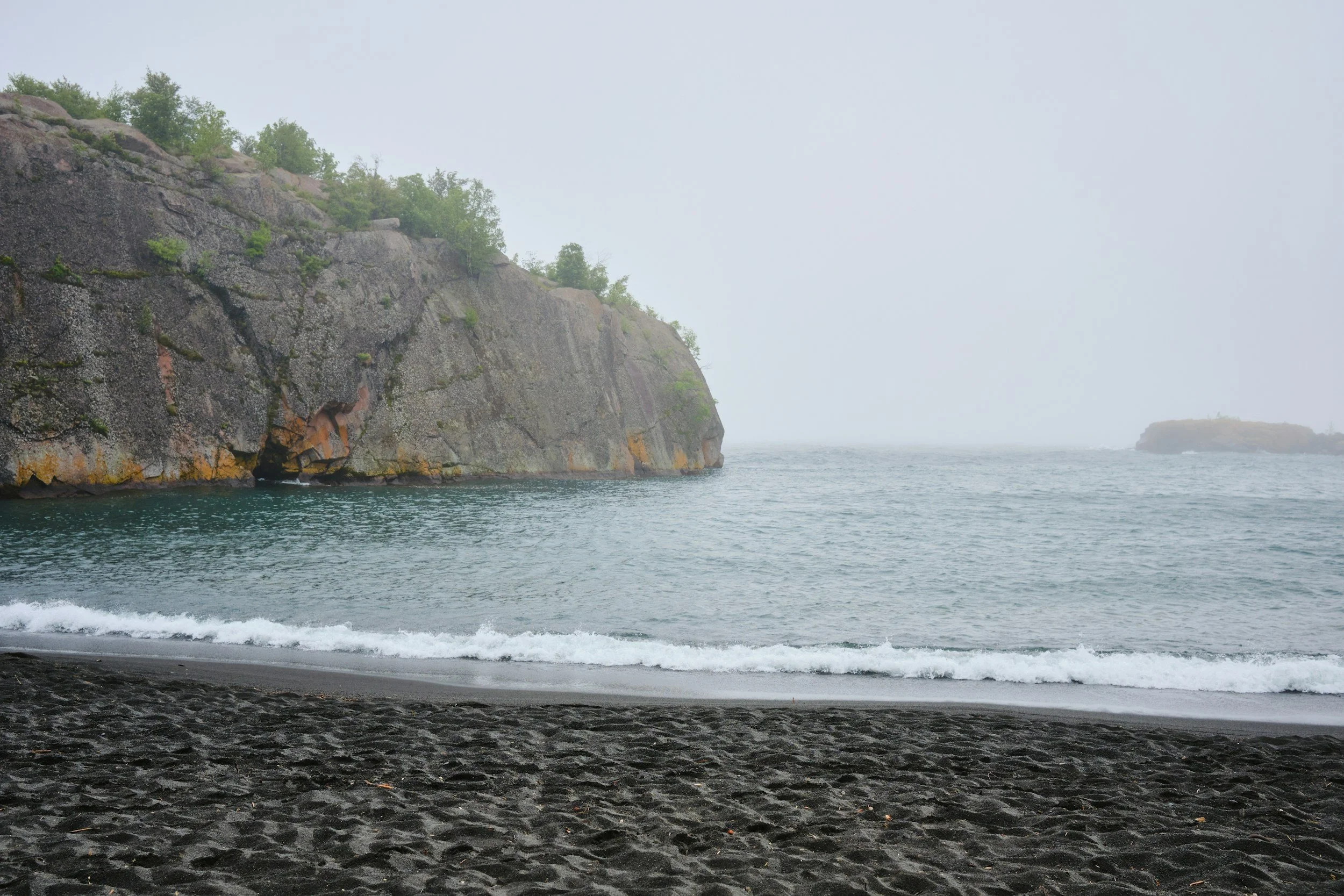 Beach with dark colored sand