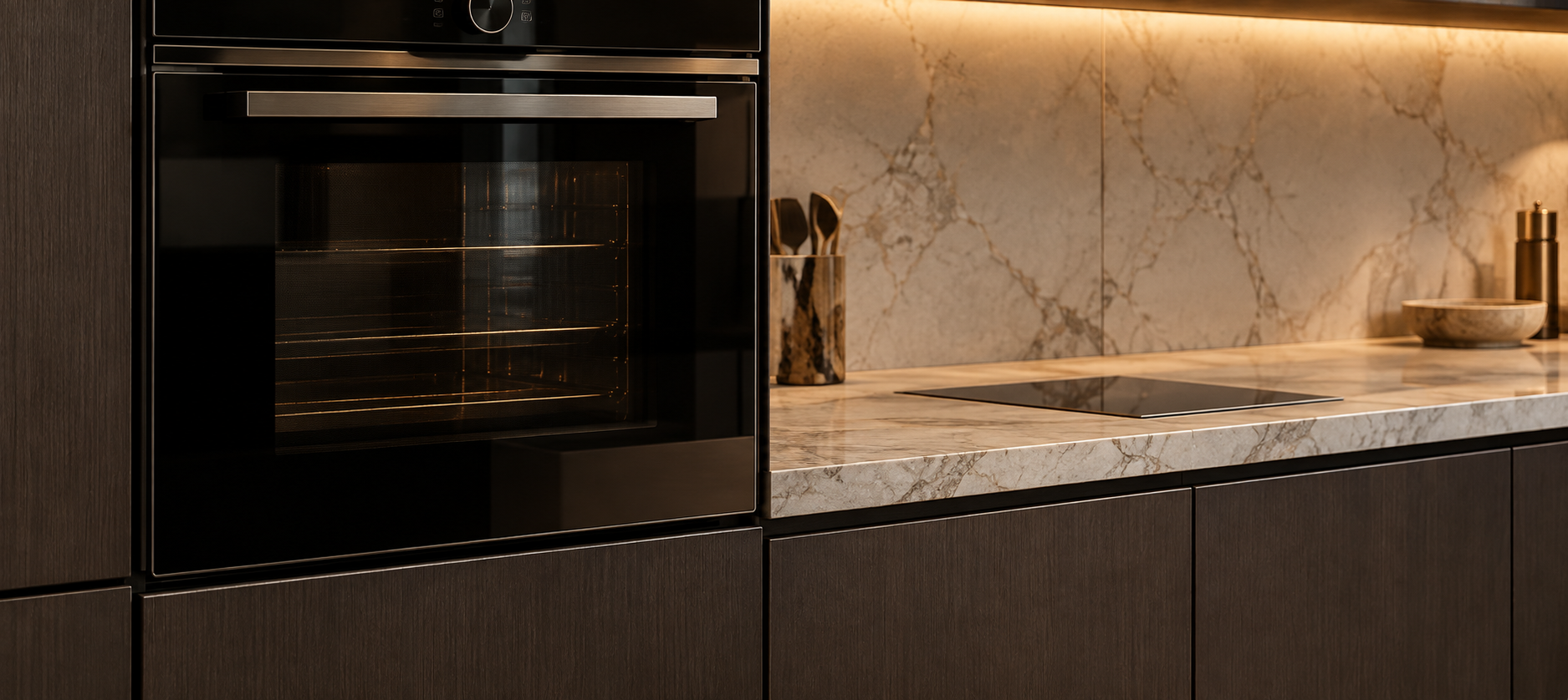 Integrated kitchen appliances coordinated within bespoke cabinetry and stone surfaces