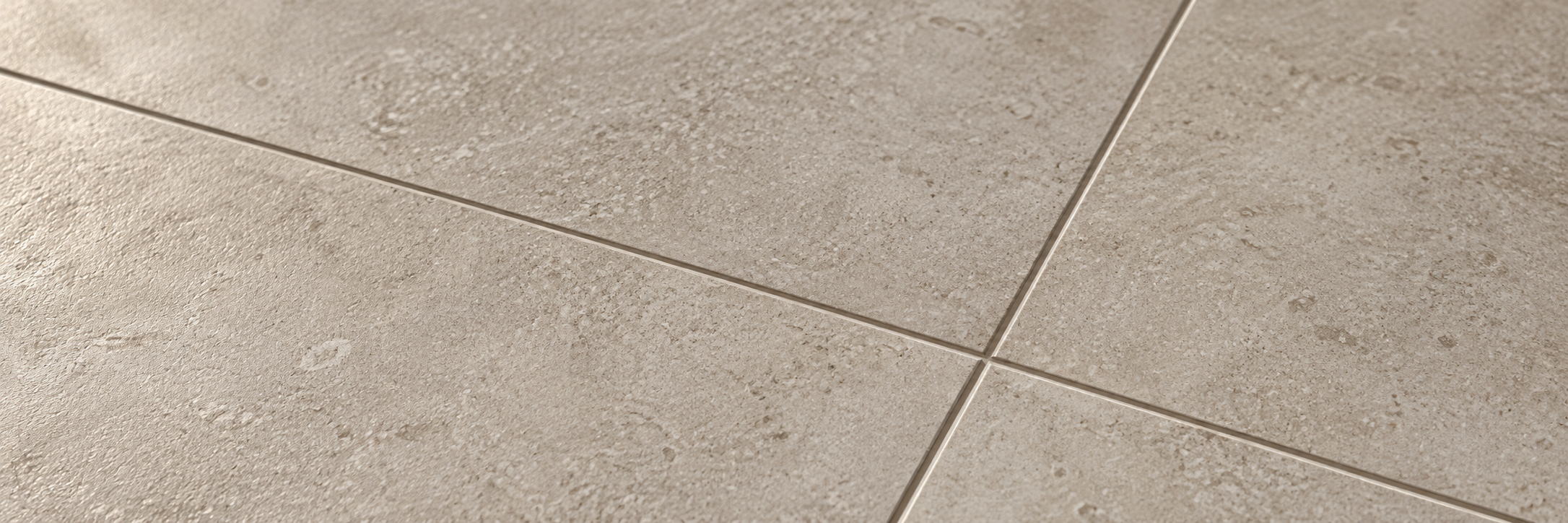 Warm greige limestone-effect porcelain tile surface