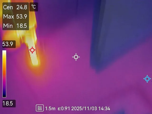 Thermal image showing a fire or hot object burning, with temperature readings up to 53.9°C, and surrounding areas at lower temperatures around 18.5°C to 24.8°C.