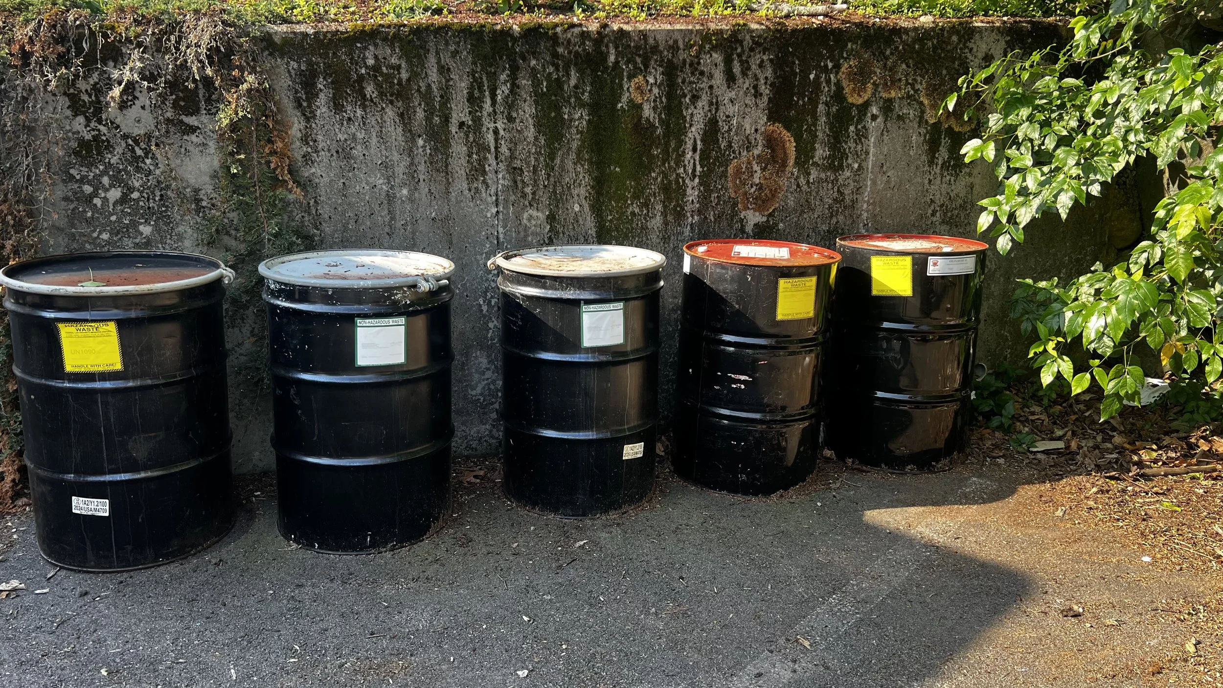 packaging and disposing old paints, oil, and flammables from a job site into 55 gallon drums