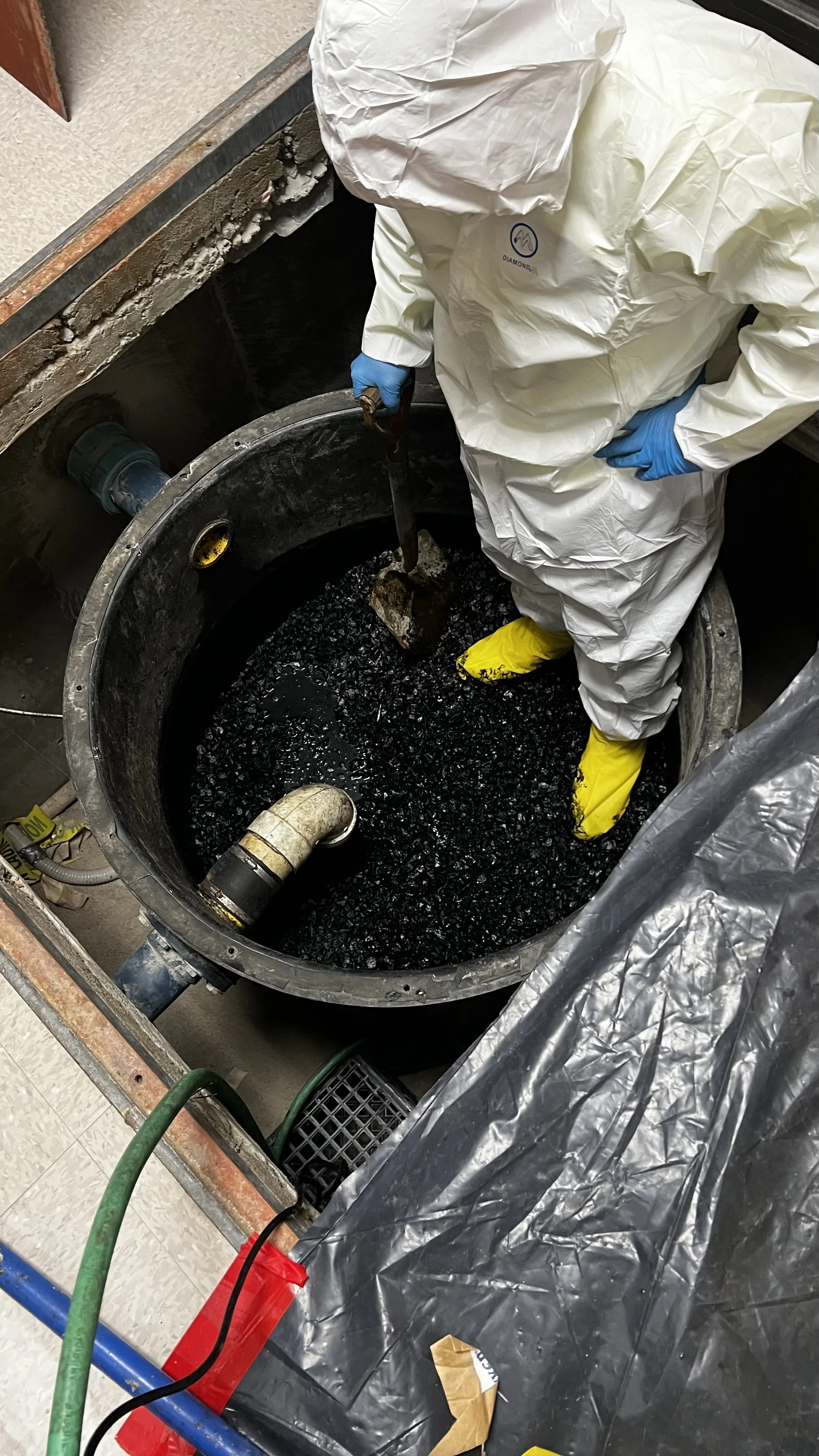 removing, disposing, and replacing limestone chips from a neutralization tank