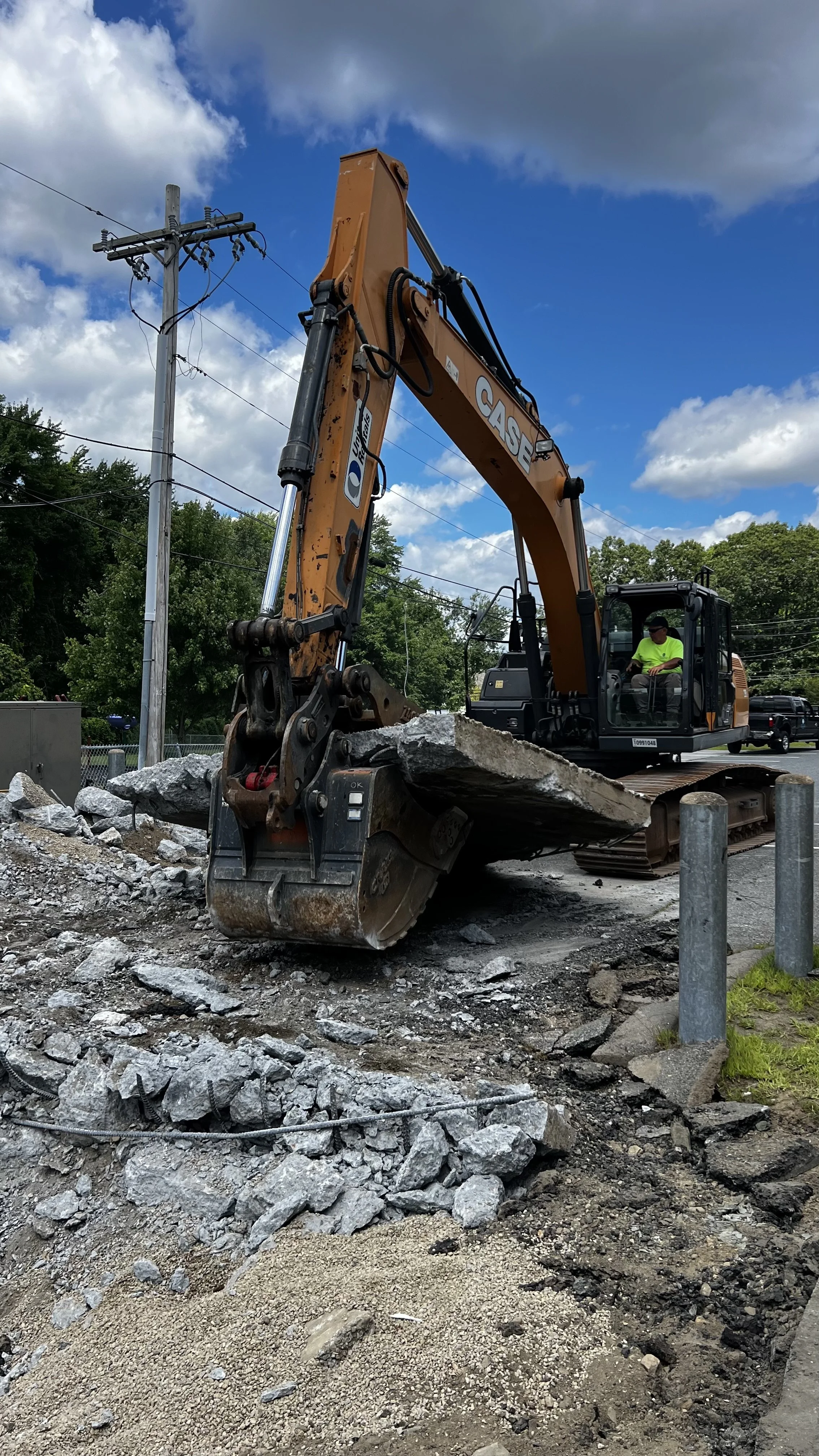 disposing of foundation with excavator