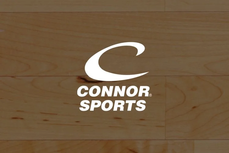 Connor Sports logo with a large white 'C' on wooden flooring.