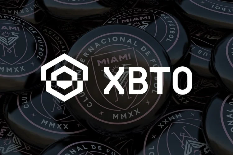 Close-up of black poker chips with Miami crest, overlayed with XBT and an XBT logo.
