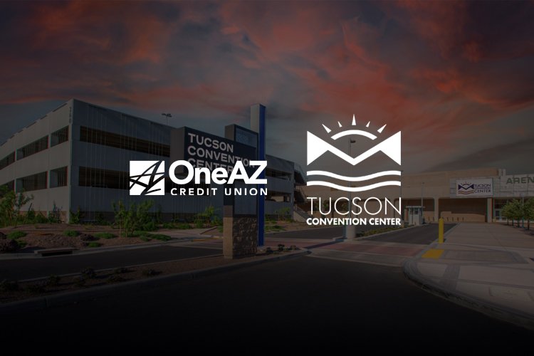 Exterior view of the Tucson Convention Center with logos for OneAZ Credit Union and Tucson Convention Center in the foreground during sunset.