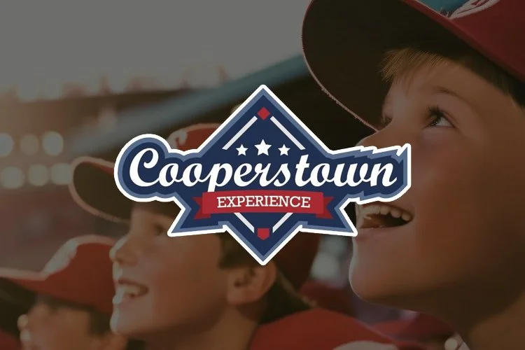A group of children wearing red caps, smiling and looking excited at a sports event with a 'Cooperstown Experience' logo overlay.