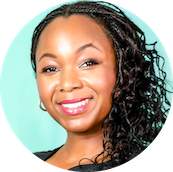 Close-up portrait of a smiling woman with long curly black hair and hoop earrings against a turquoise background.