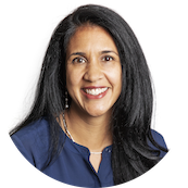 A woman with long black hair wearing a dark blue top, smiling