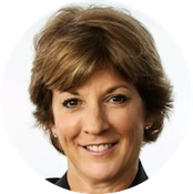 A woman with short brown hair smiling against a white background.