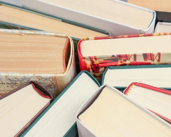 Stack of colourful hardback books.