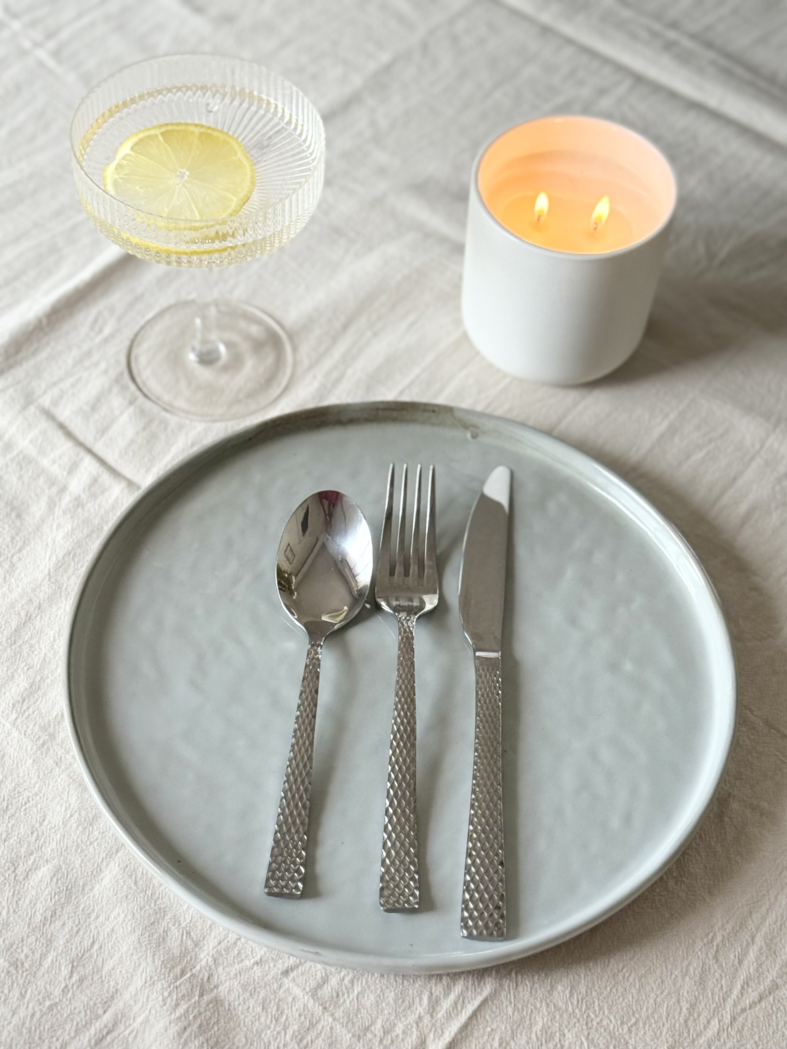 Plate with candle and lemon water.jpeg