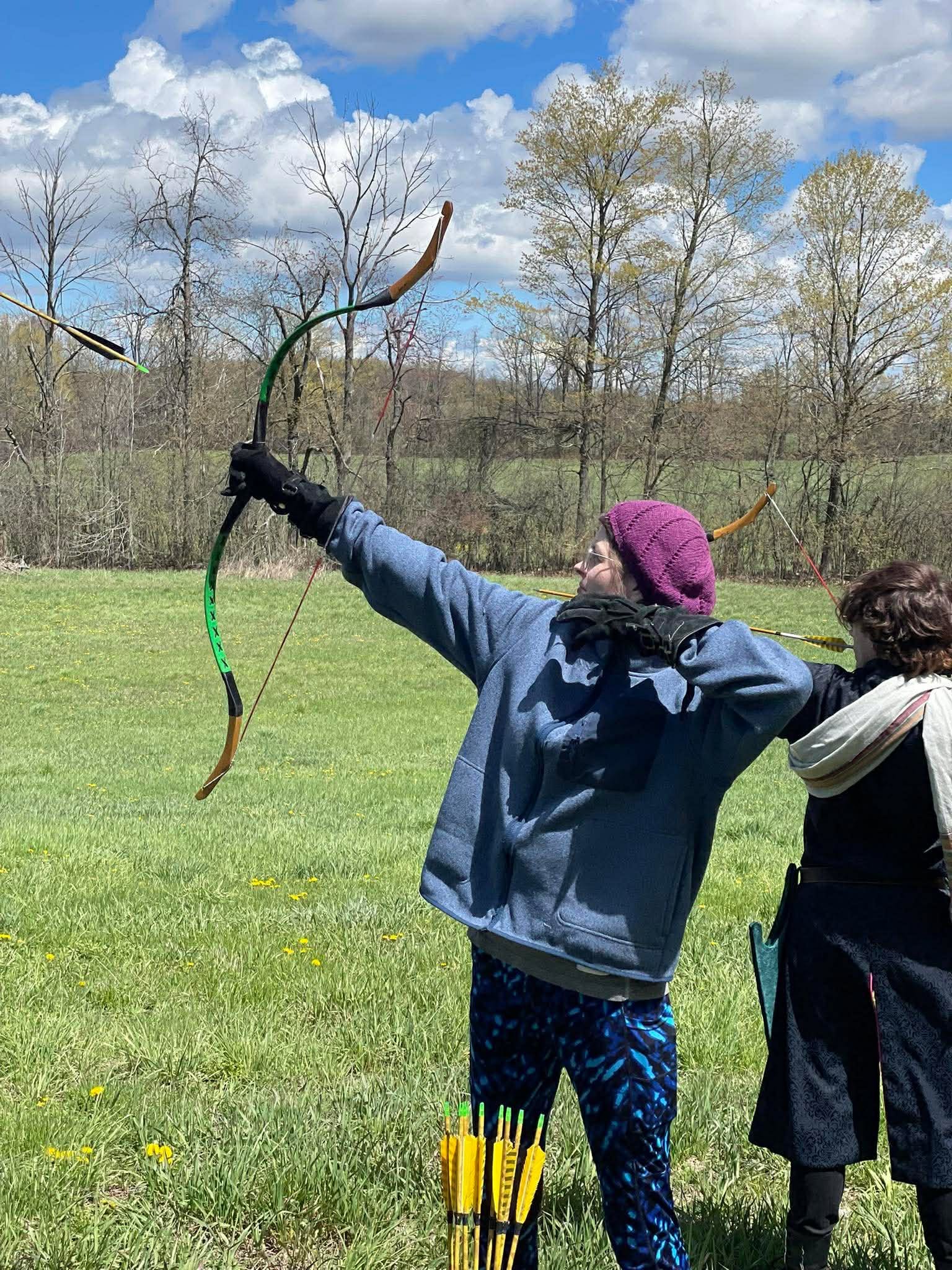 Young woman shooting a recurve bow
