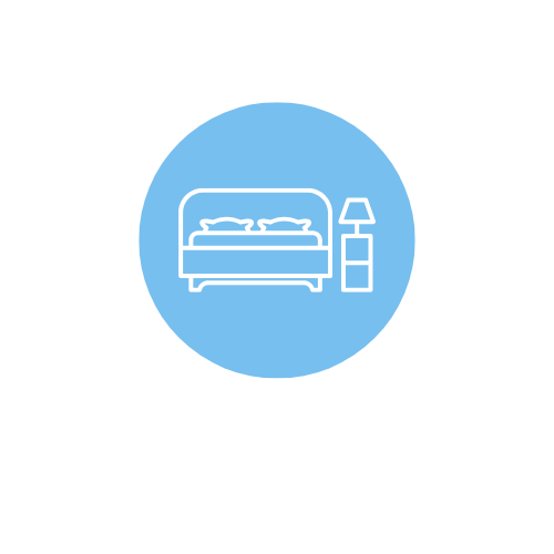 Outline of a bed with a pillow and blanket, next to a nightstand and lamp, inside a blue circle.