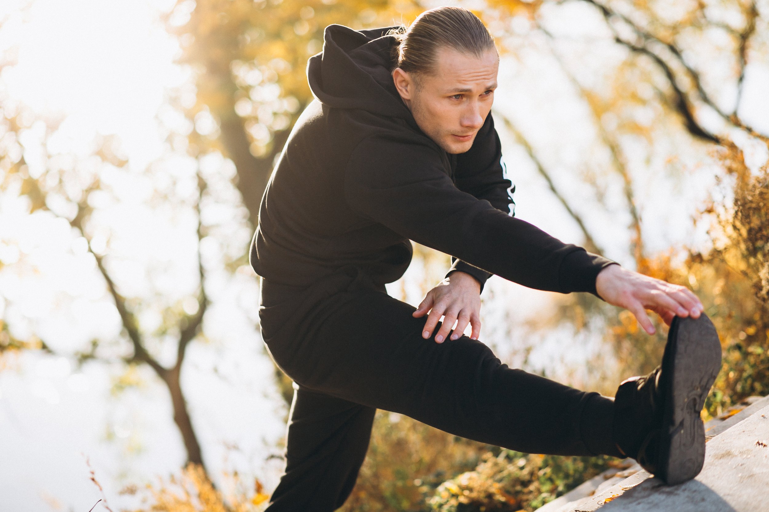 A man stretching his legs before his workout - Calm Harbor Counseling