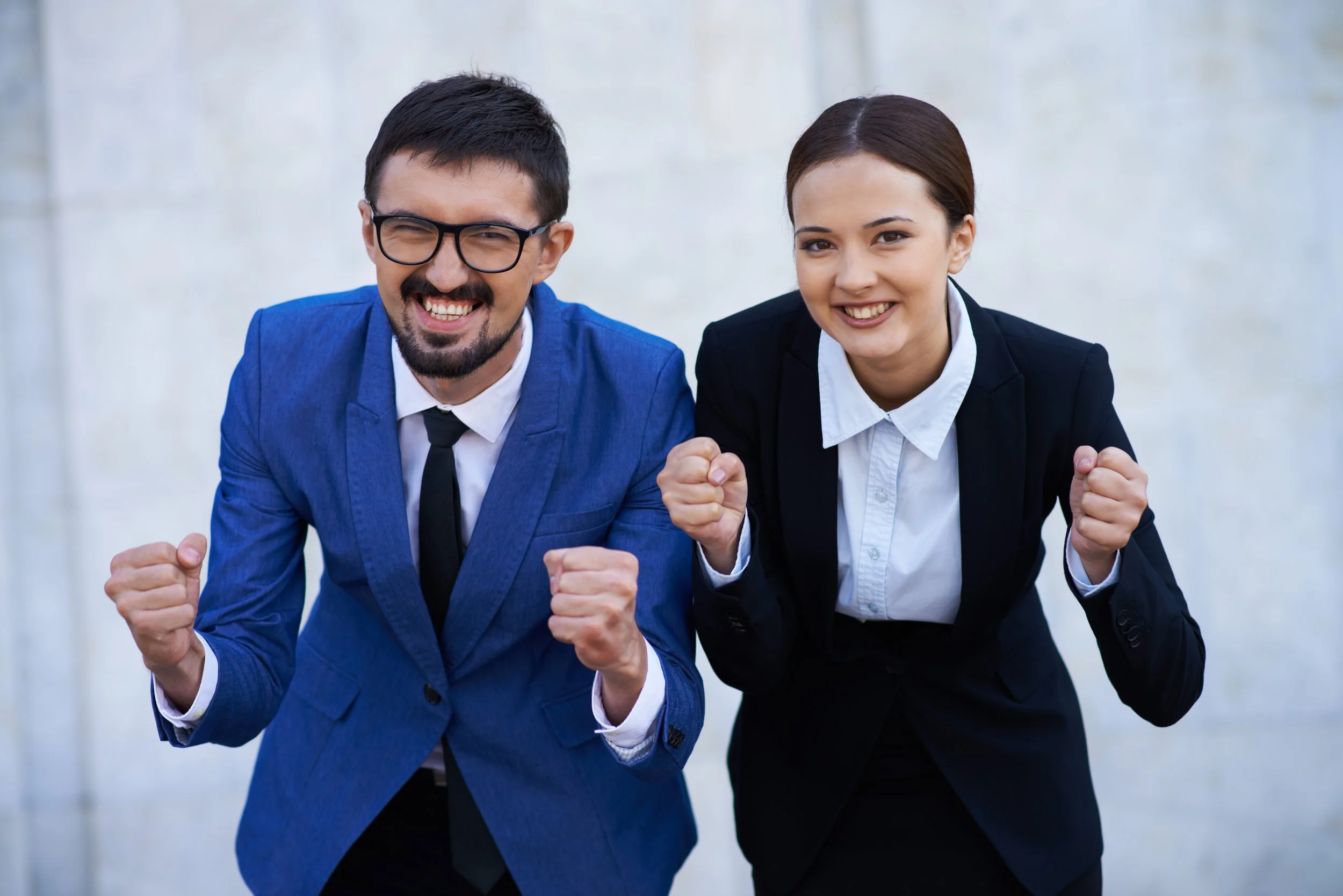 Two business professionals celebrating  their career success - Calm Harbour Counseling