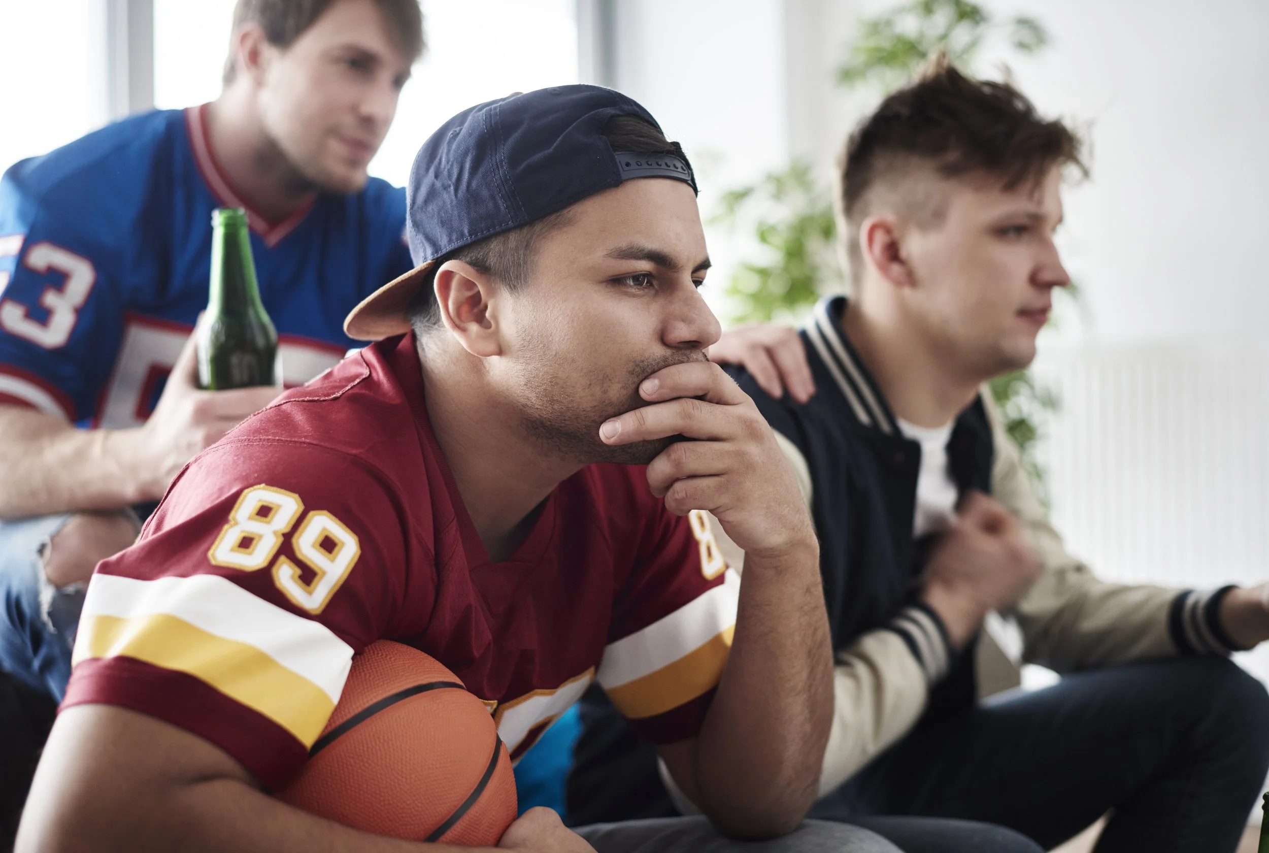 An image of football fans focusing on the game they’re watching - Calm Harbor Counseling 