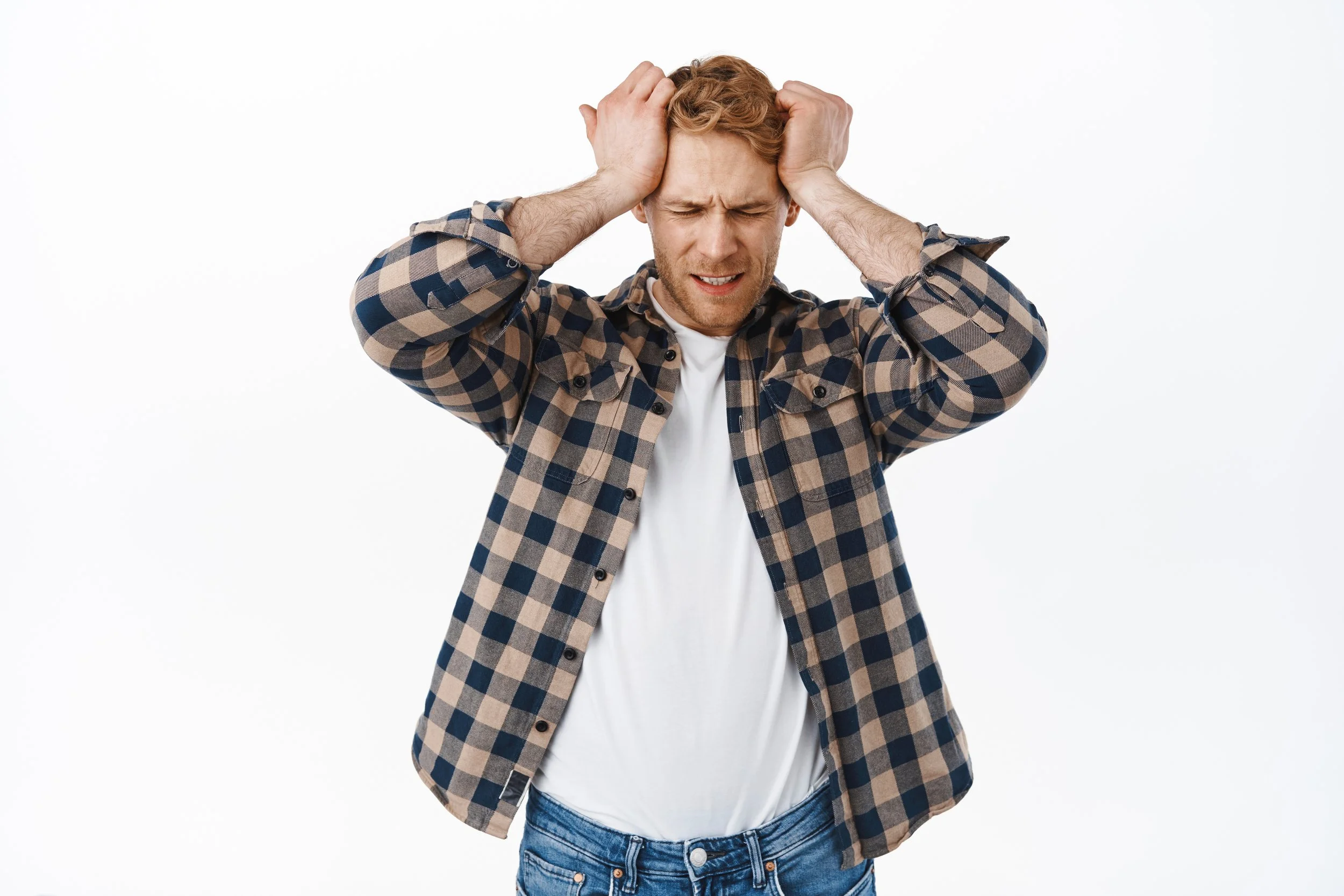 A man with his hands on his head indicating that he is stressed out - Calm Harbor Counseling