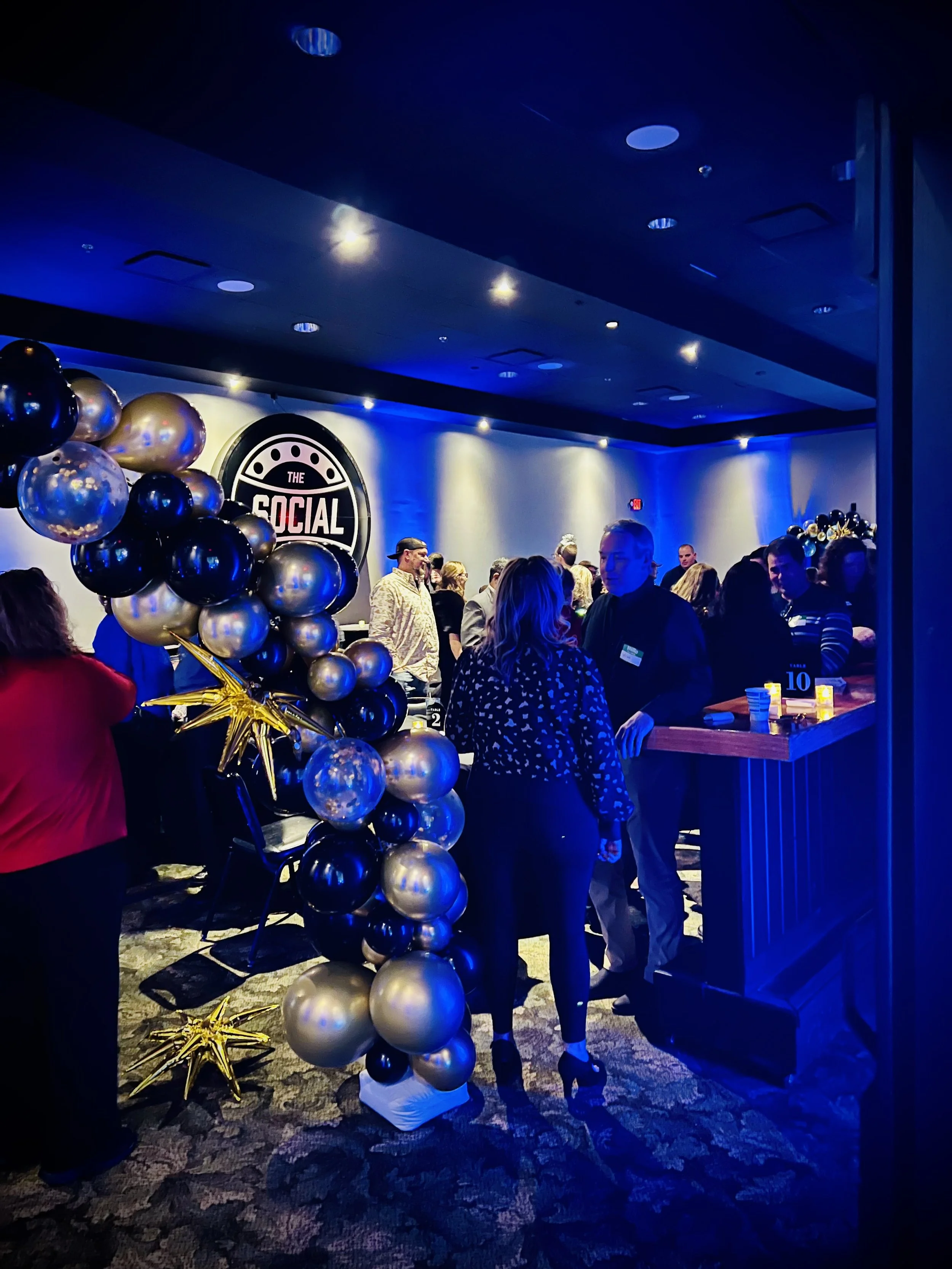 Guests socializing inside a decorated venue during an evening in-person dating event