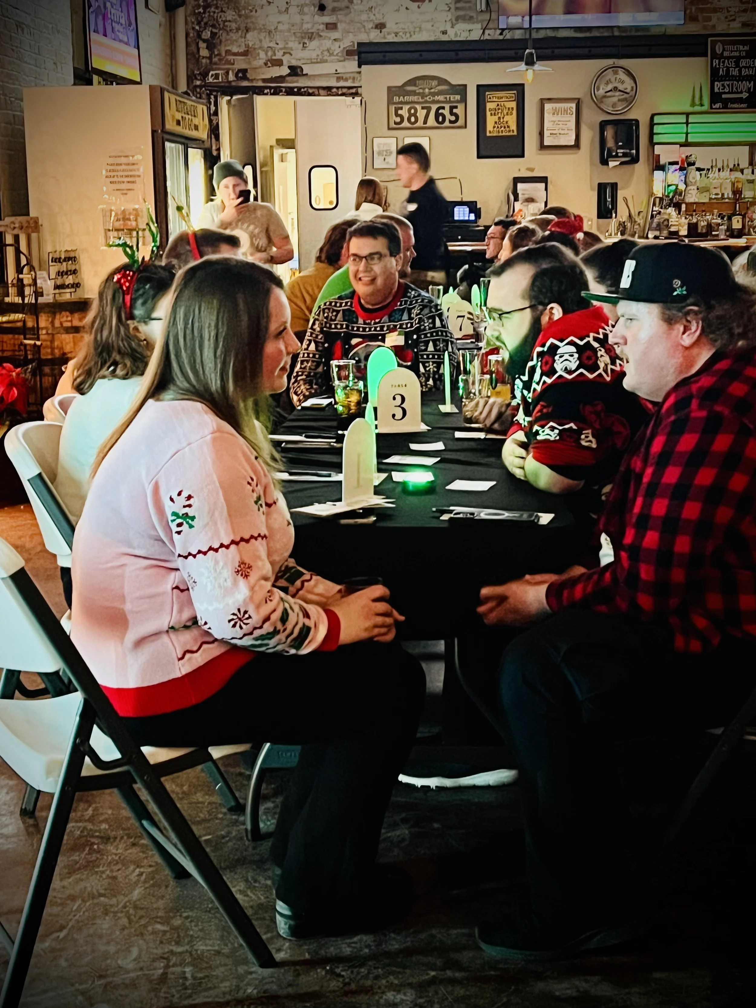 Singles seated across from each other and talking during a speed dating event