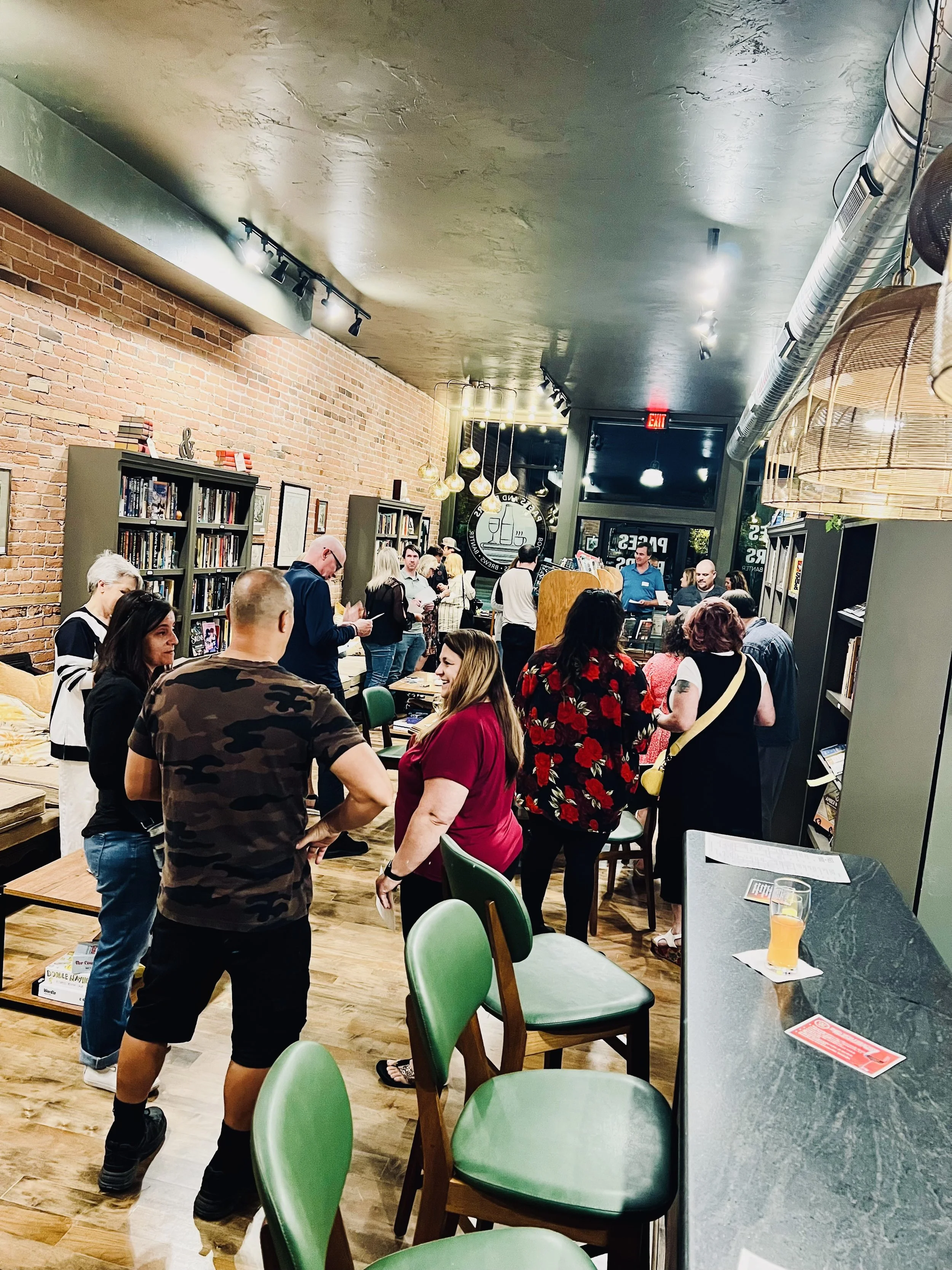 Singles walking, standing, and talking together during a busy in-person dating event.