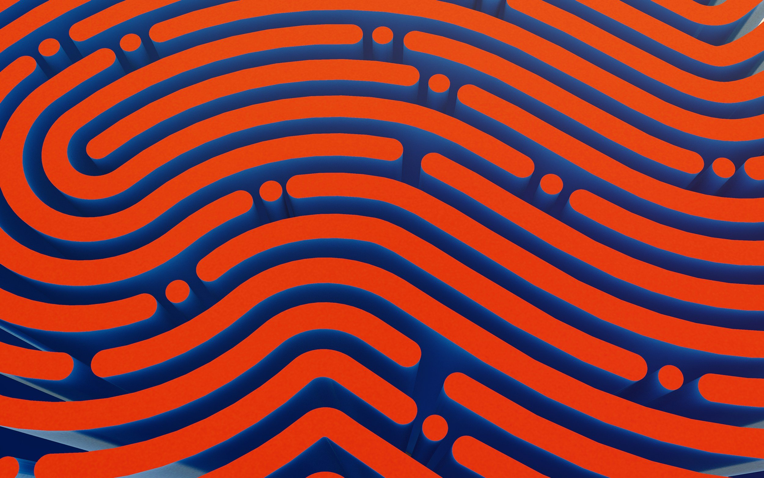 A close-up of a modern art sculpture with orange curving lines and circular shapes on a blue background.