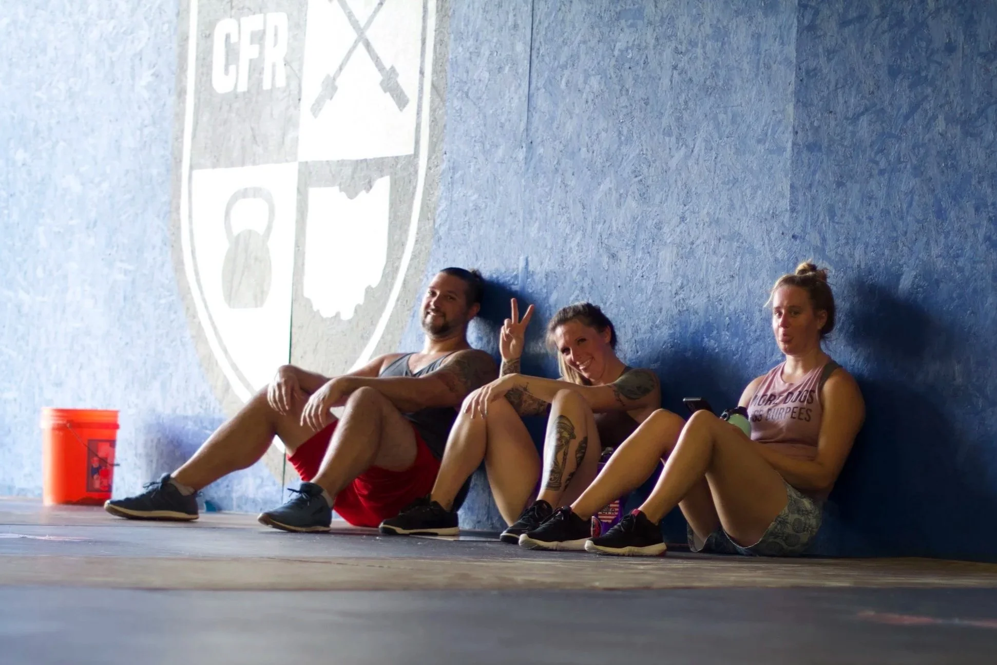 Members of CrossFit Regulate encouraging and celebrating after workout