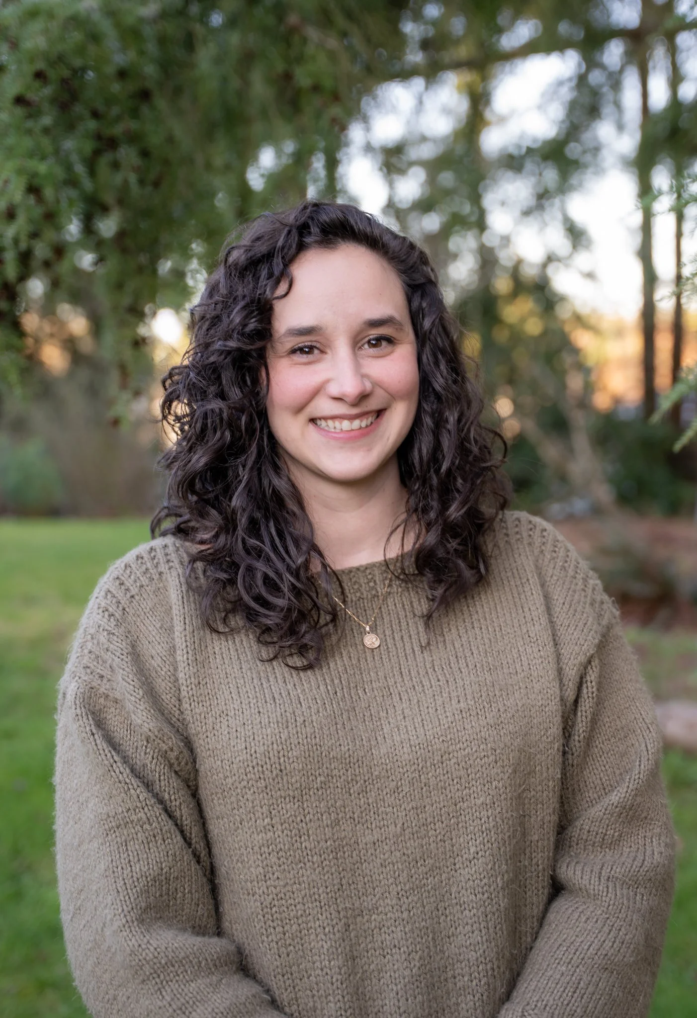 Dr. Jessica Farrah, a smiling curly-haired audiologist who co-founder of Harmony Audiology in Mountlake Terrace, Washington.